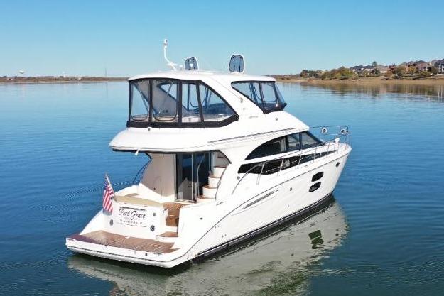 2016 Meridian 441 yacht on calm water with clear blue sky.
