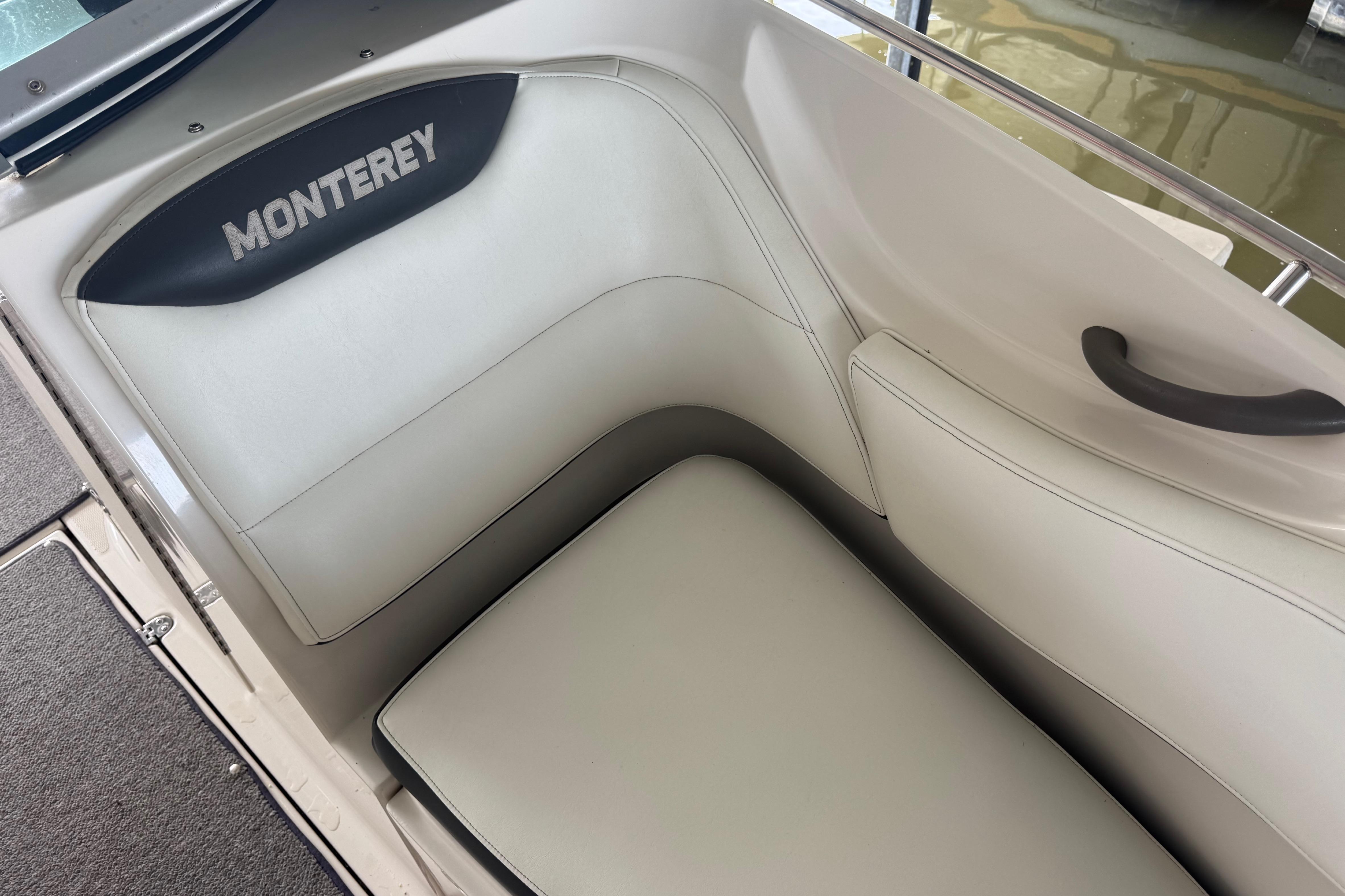2005 Monterey 248LS Montura Bowrider interior seating with logo, featuring white upholstery.