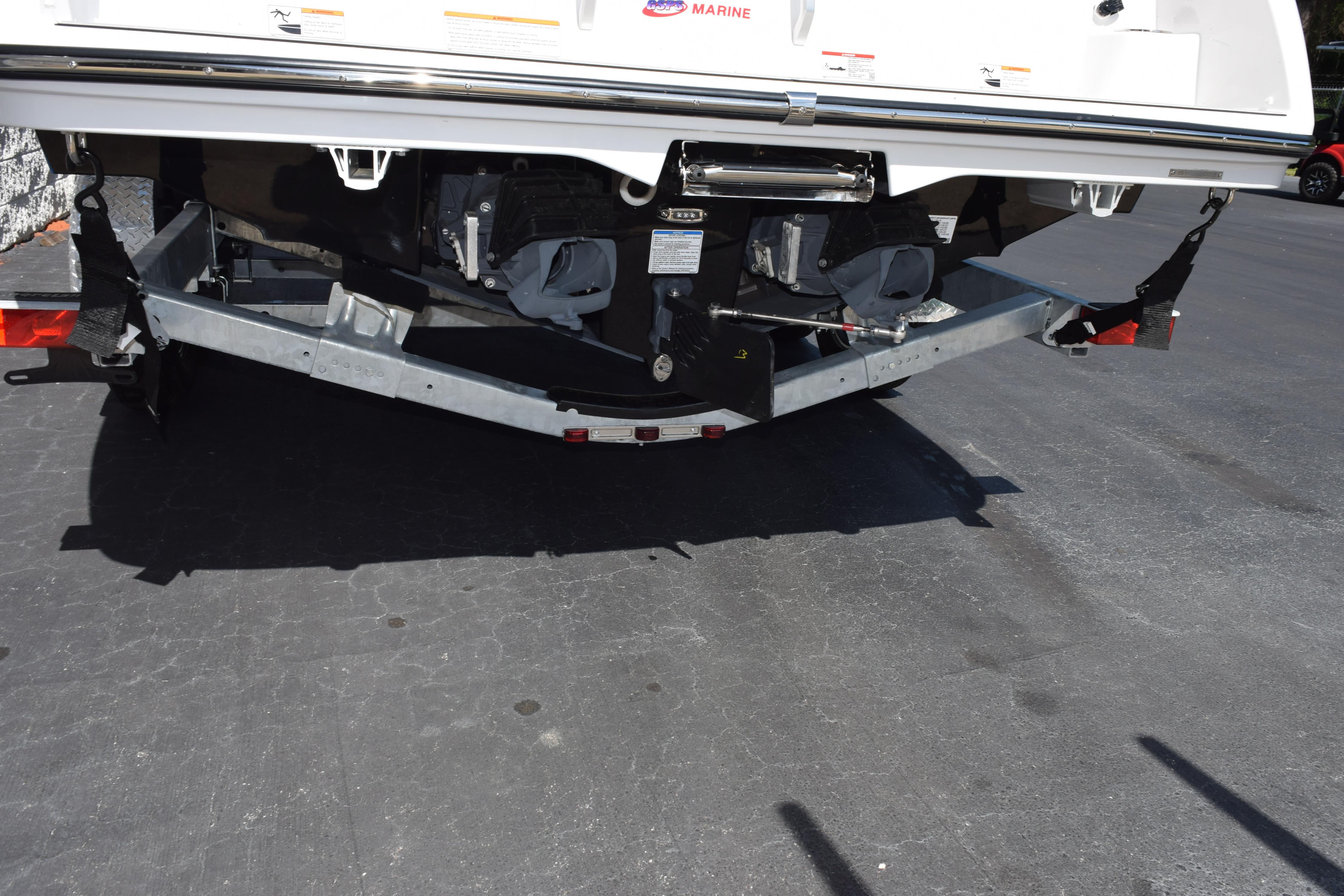 Rear view of 2026 Yamaha Boats 222SE on a trailer in a parking lot.