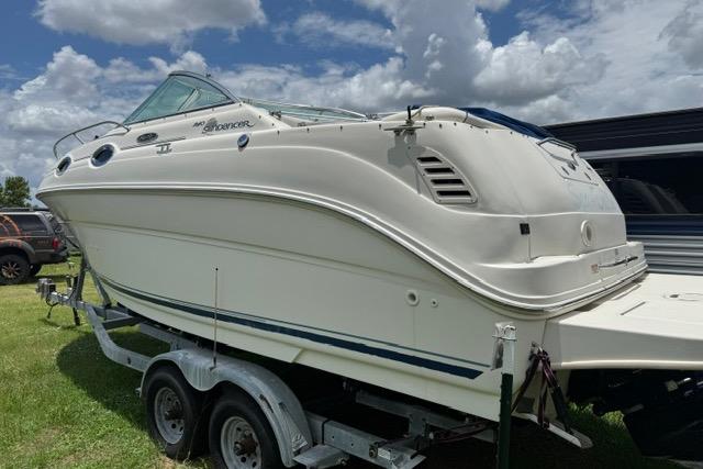 2004 Sea Ray 240 Sundancer boat on trailer under cloudy sky.