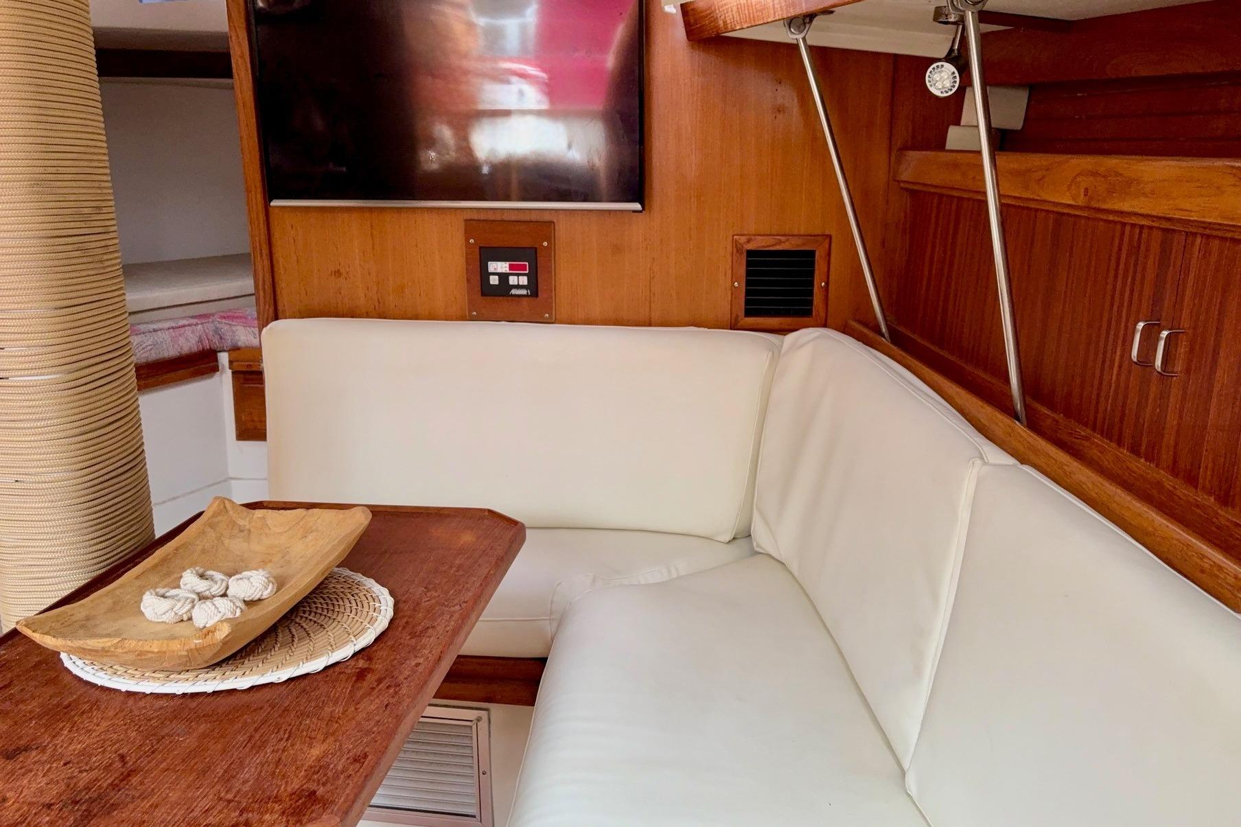 Interior of a 1992 Catalina 34 sailboat with white seating and wooden accents.