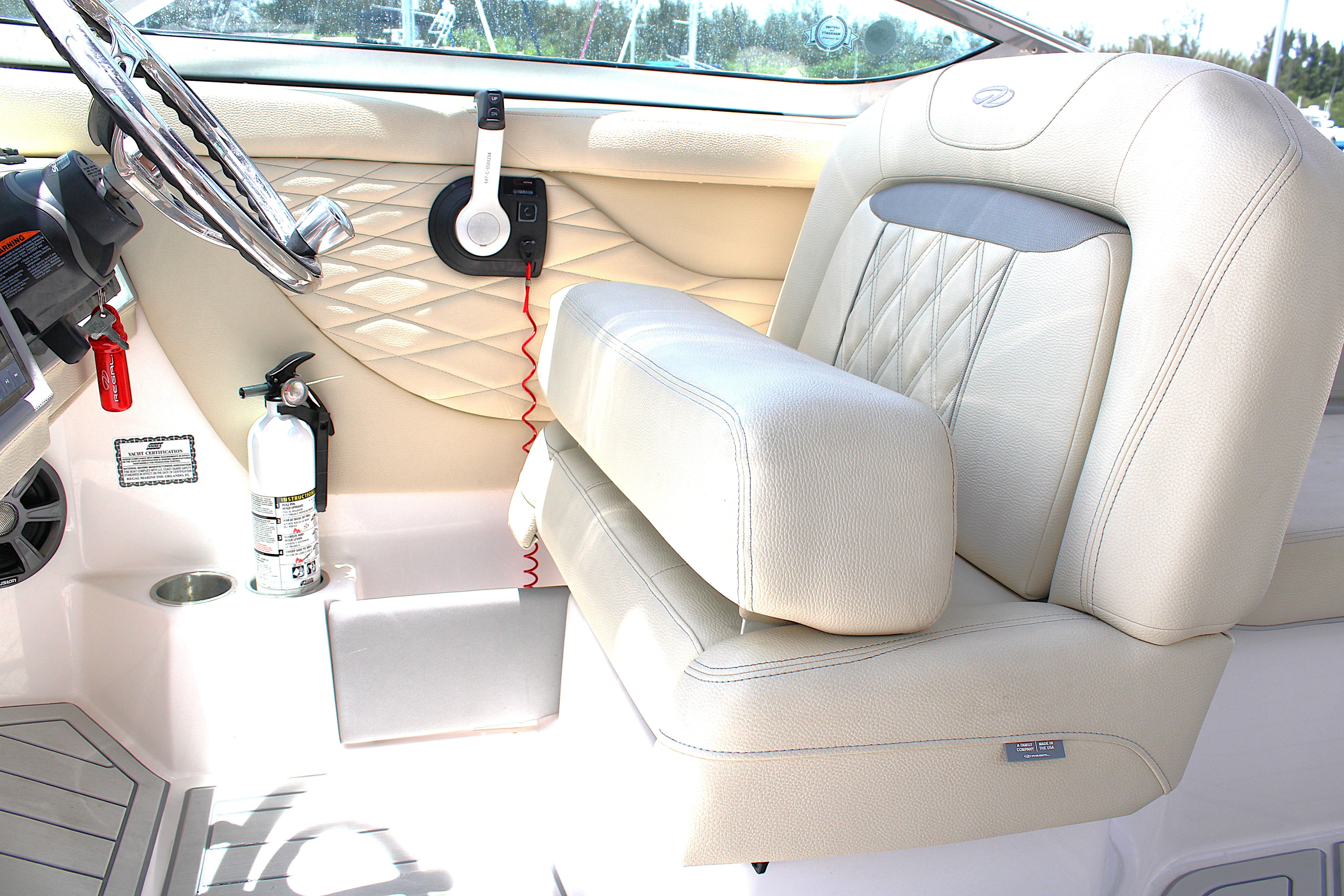 2021 Regal 26 OBX boat interior with beige seating and steering wheel.