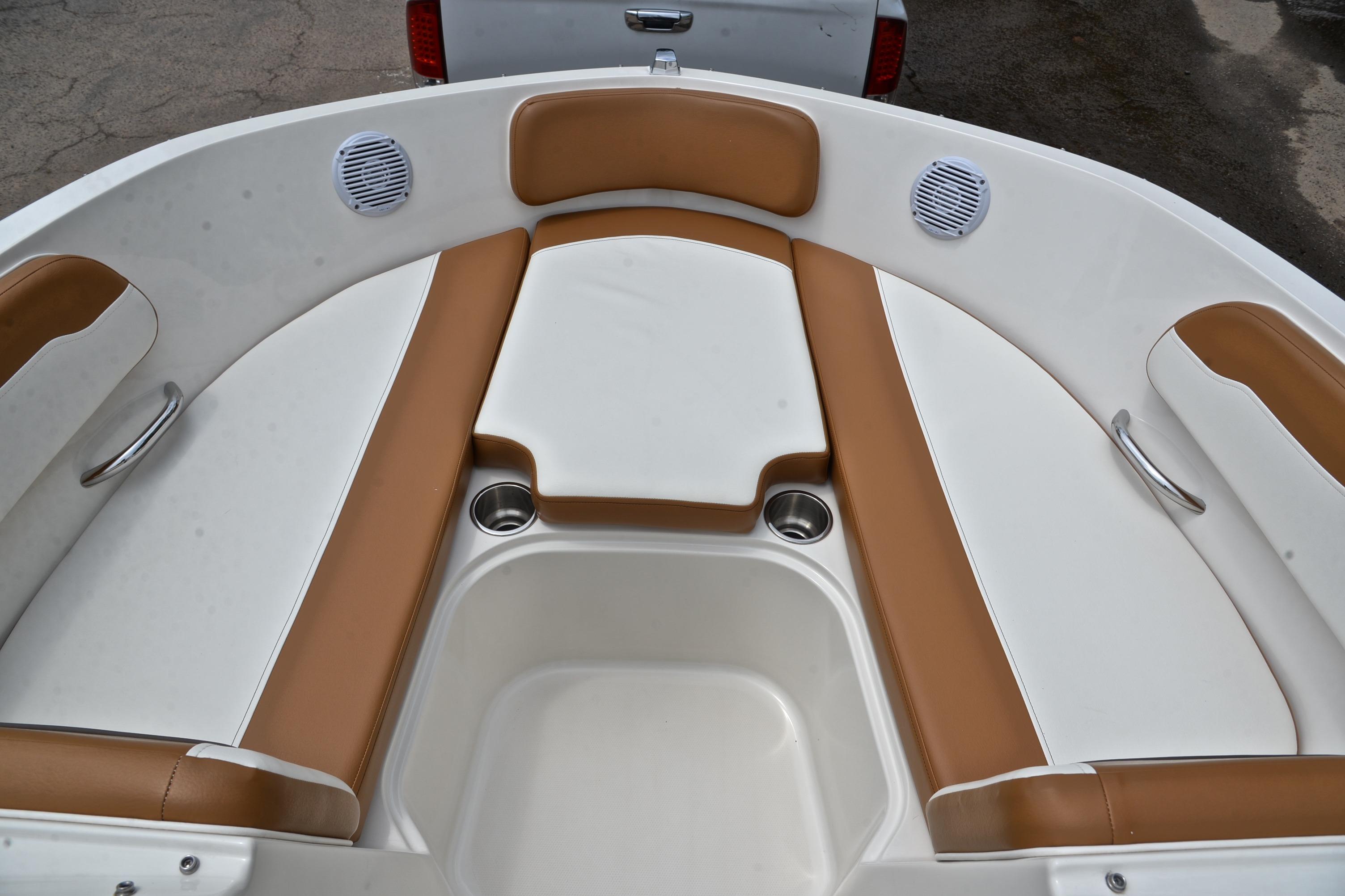 2019 Bayliner VR6 Bowrider OB interior with tan and white seating, cup holders, and speakers.