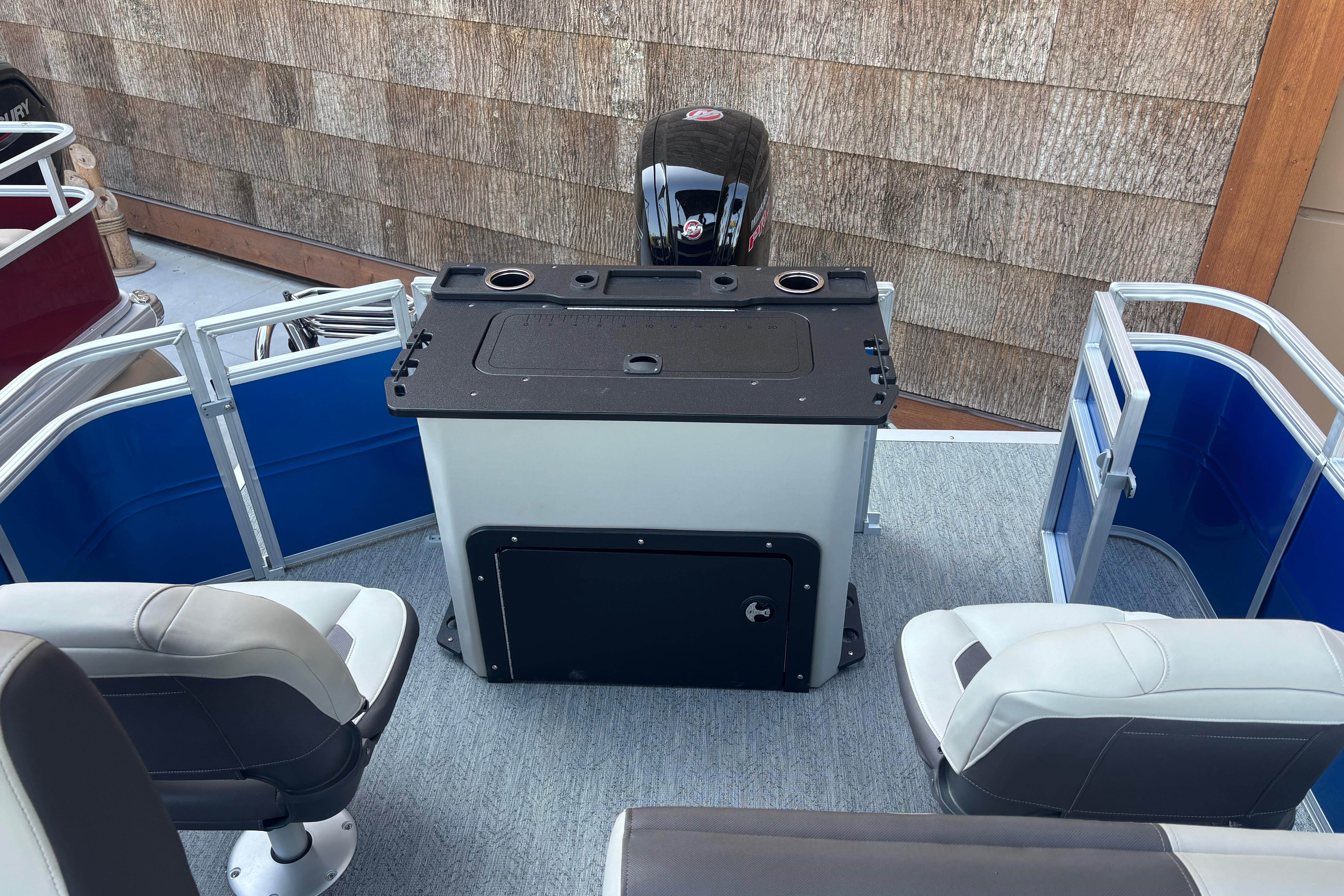 2026 Sun Tracker Fishin' Barge 20 DLX interior with seating and control console.