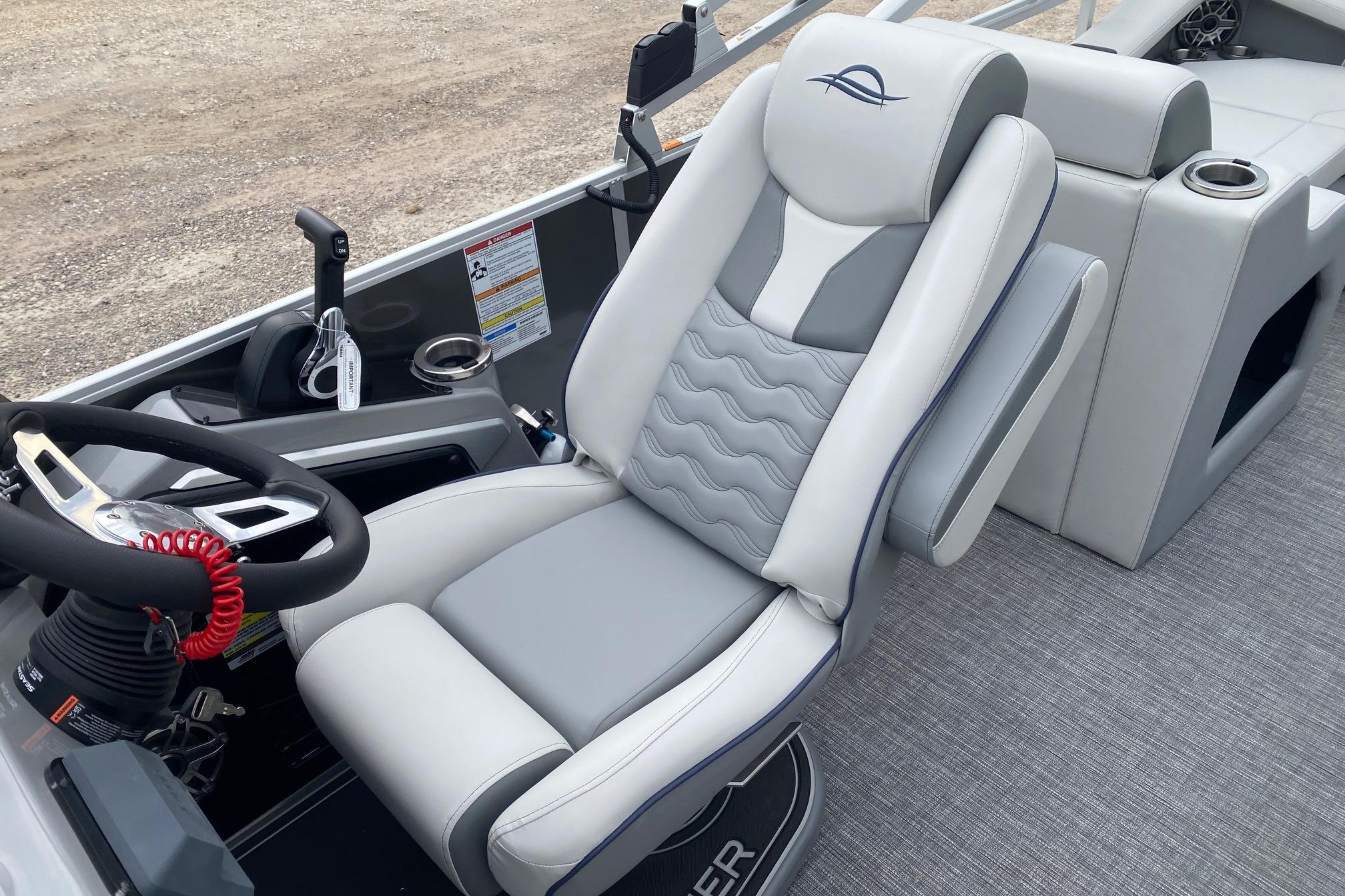 2026 SunCatcher Diamond Elite 324 SS boat interior with luxurious captain's chair and steering console.