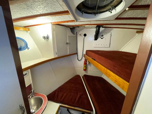 1951 Chris-Craft Catalina cabin interior with bunk beds and sink.