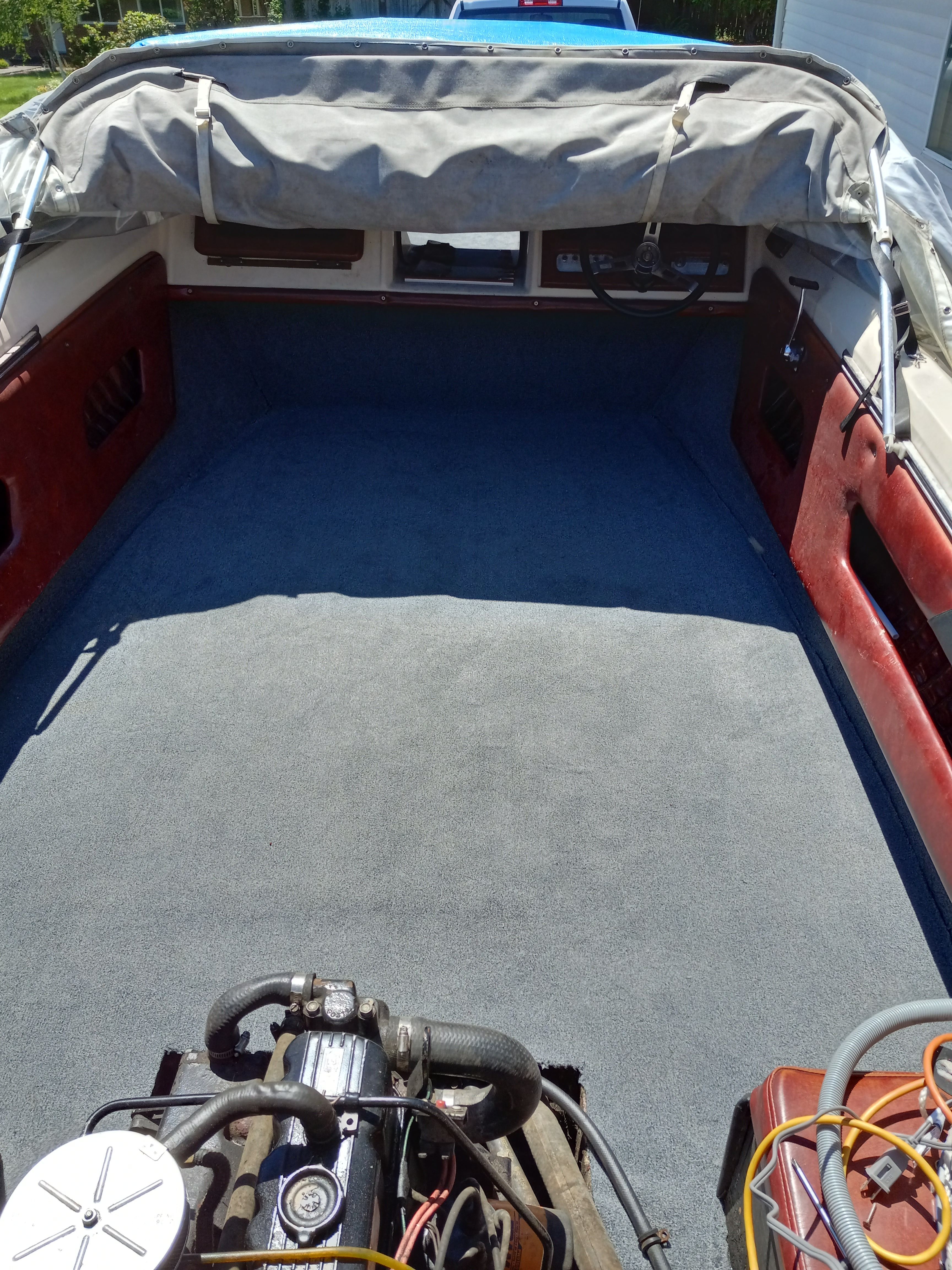 Interior of a 1977 Bayliner Jamaica boat with carpeted floor.