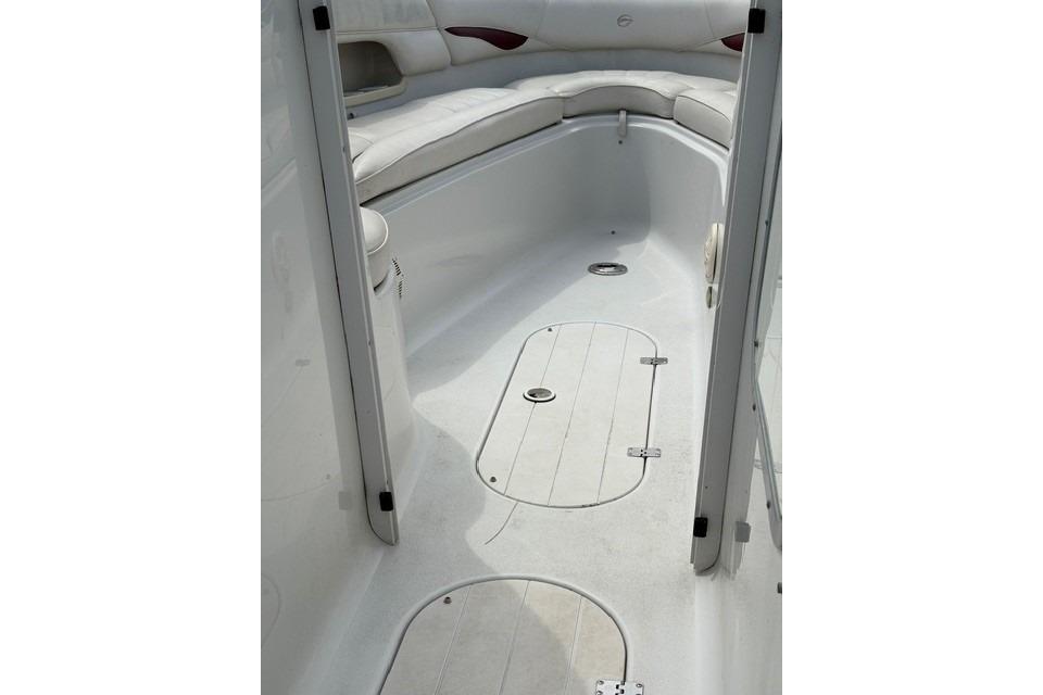 2004 Crownline 288 BR boat interior with white seating and storage compartments.