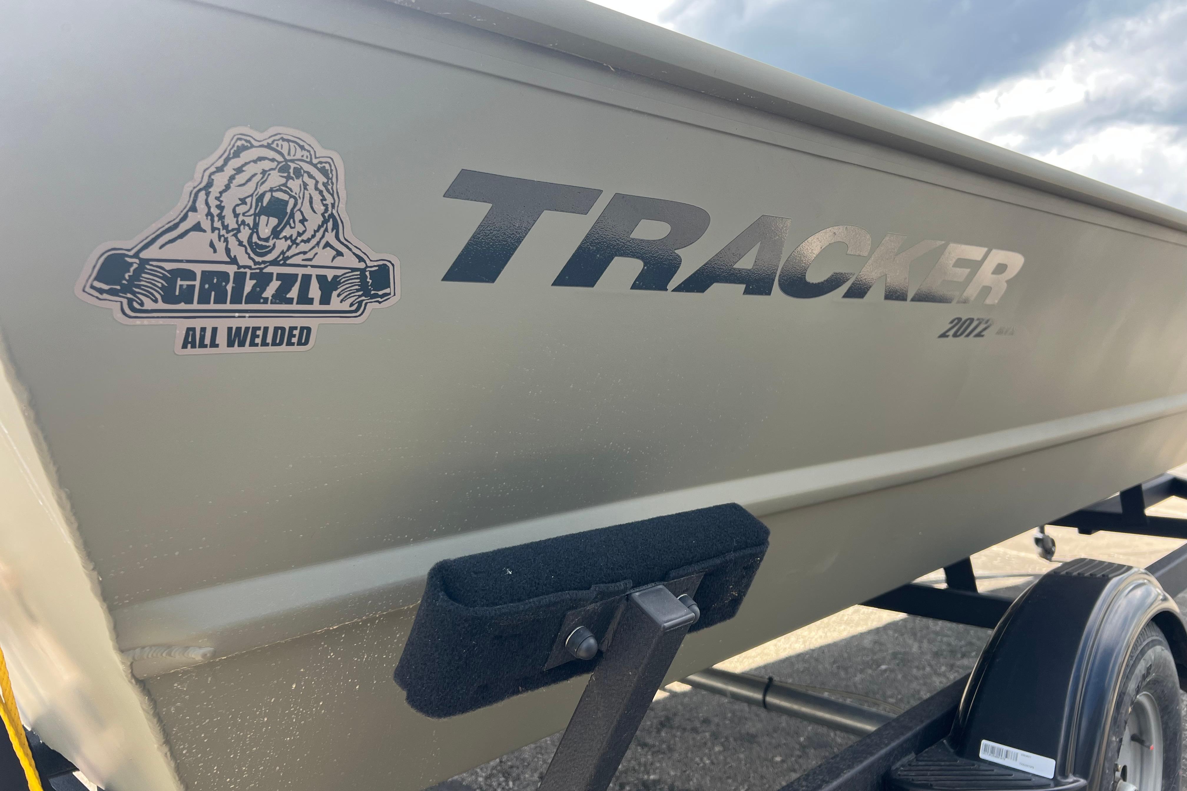 2025 Tracker Grizzly 2072 Utility boat with "All Welded" logo, side view.