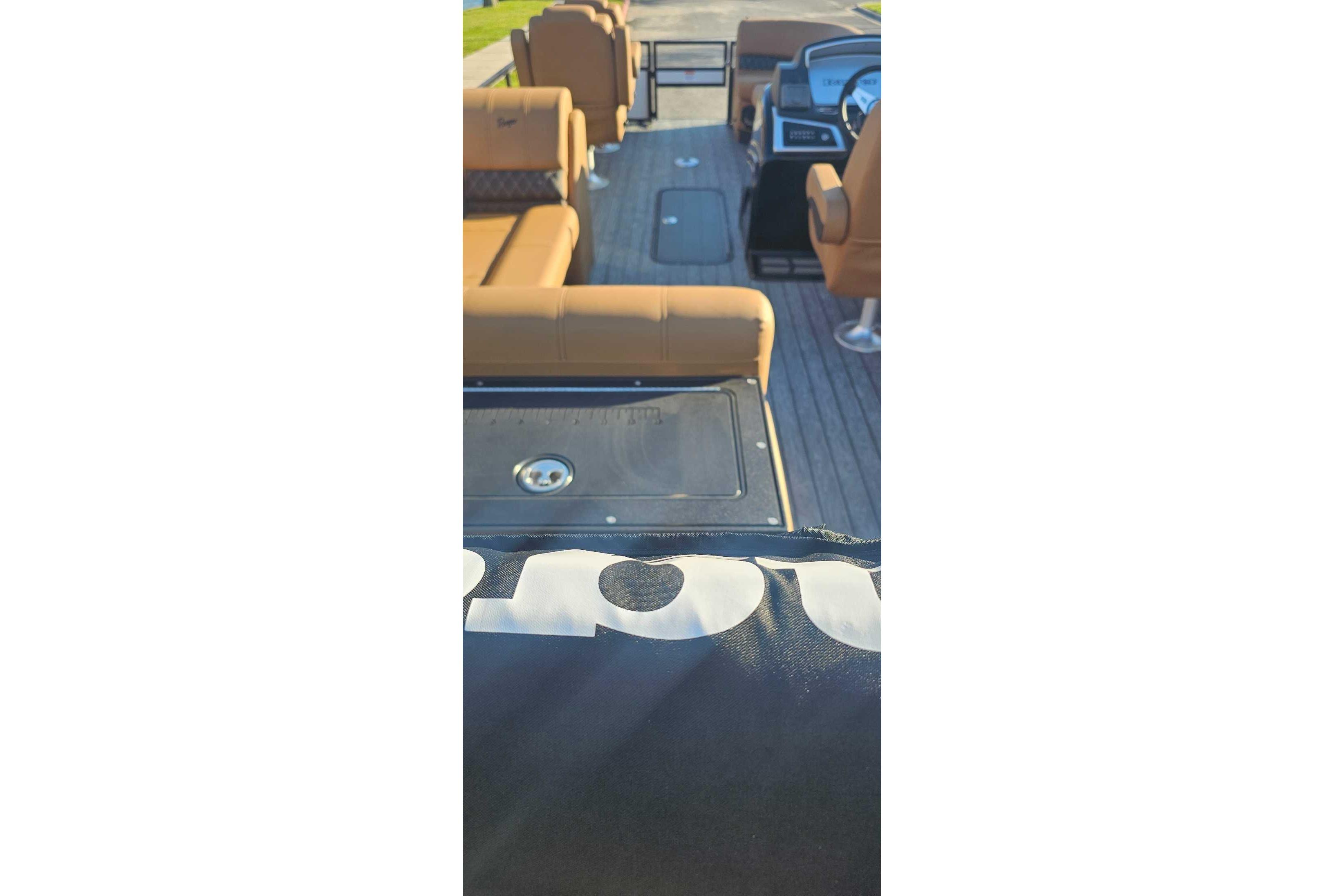 Interior view of 2026 Ranger 223FC boat with tan seating and steering console.