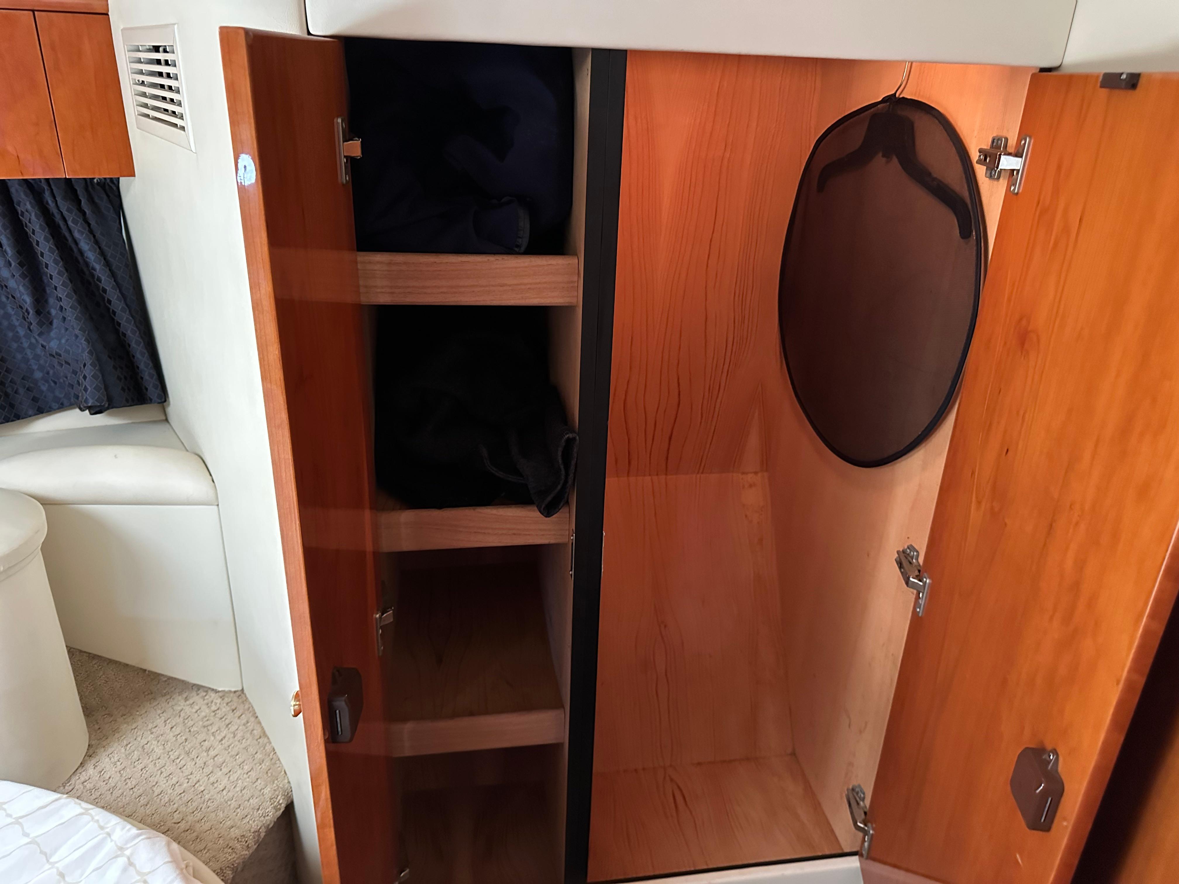 Interior of 1997 Sunseeker Camargue 47 showing wooden storage cabinets and closet space.