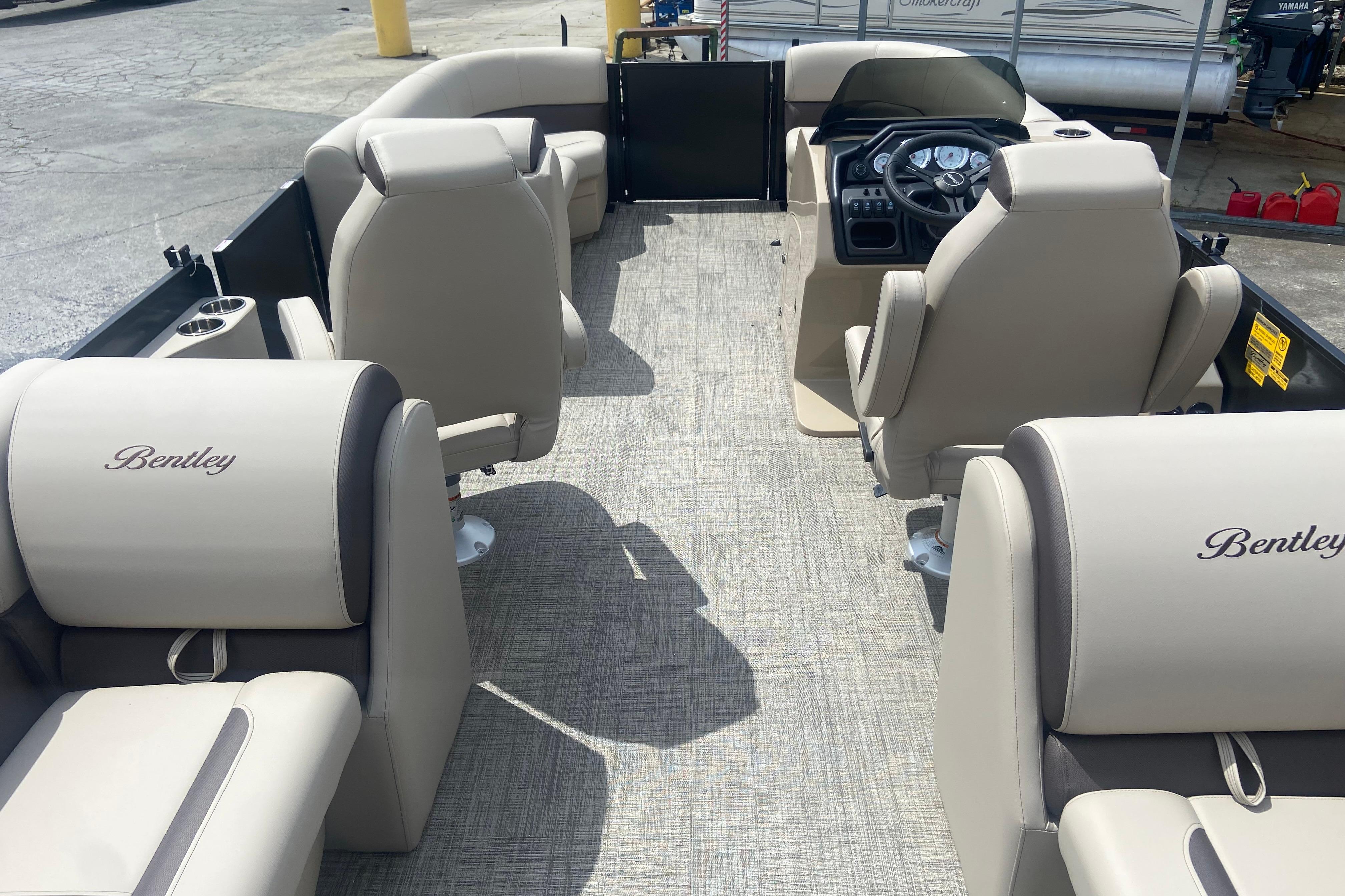 2026 Bentley Pontoons Legacy 223 Navigator interior with beige seating and steering console.