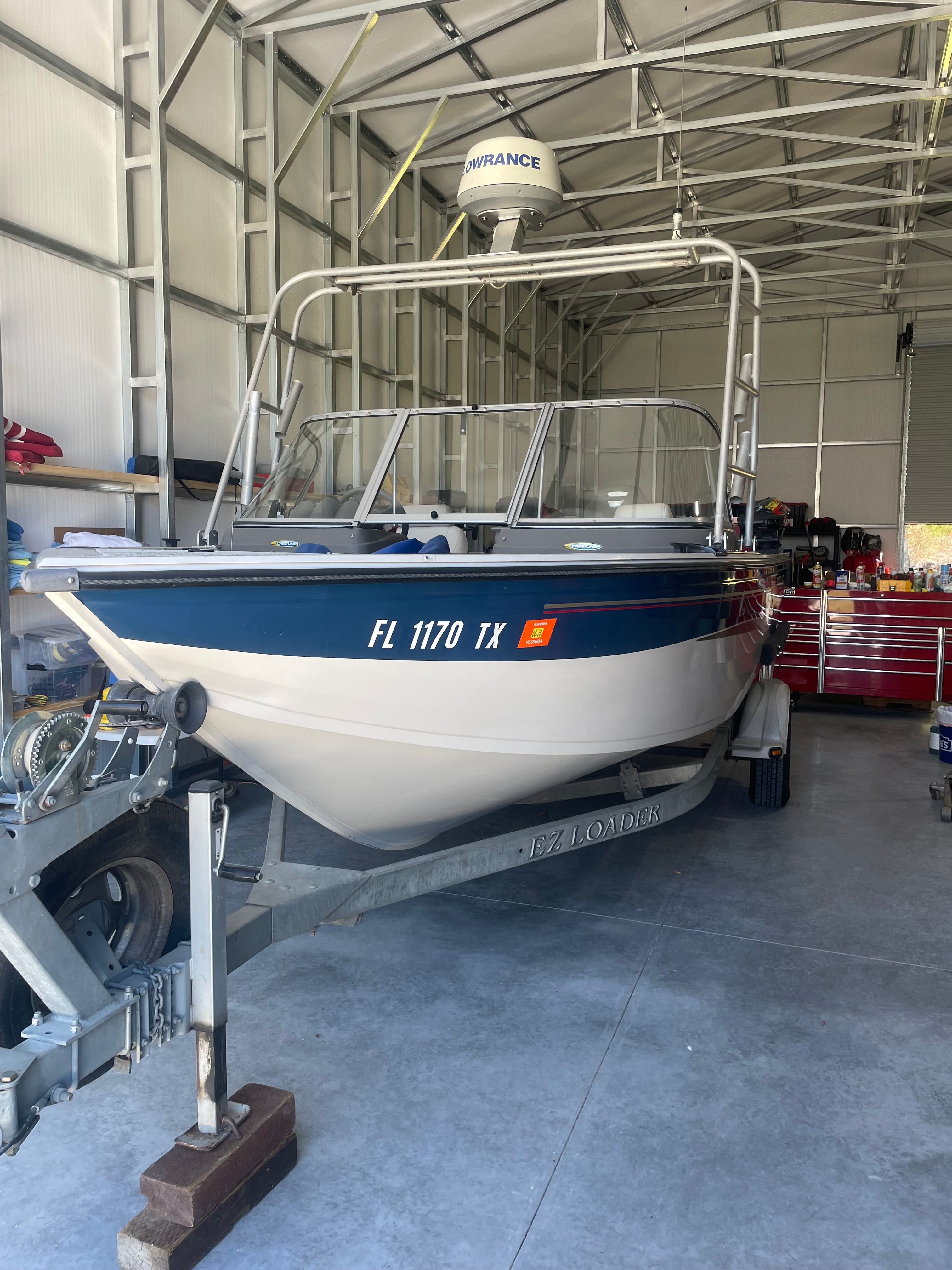 2007 Crestliner Mirage 2000 boat in a garage on a trailer.