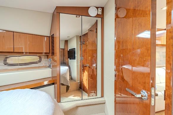 Luxurious interior of 2016 Sea Ray Sundancer 510 yacht with wood finishes and mirrored closet.