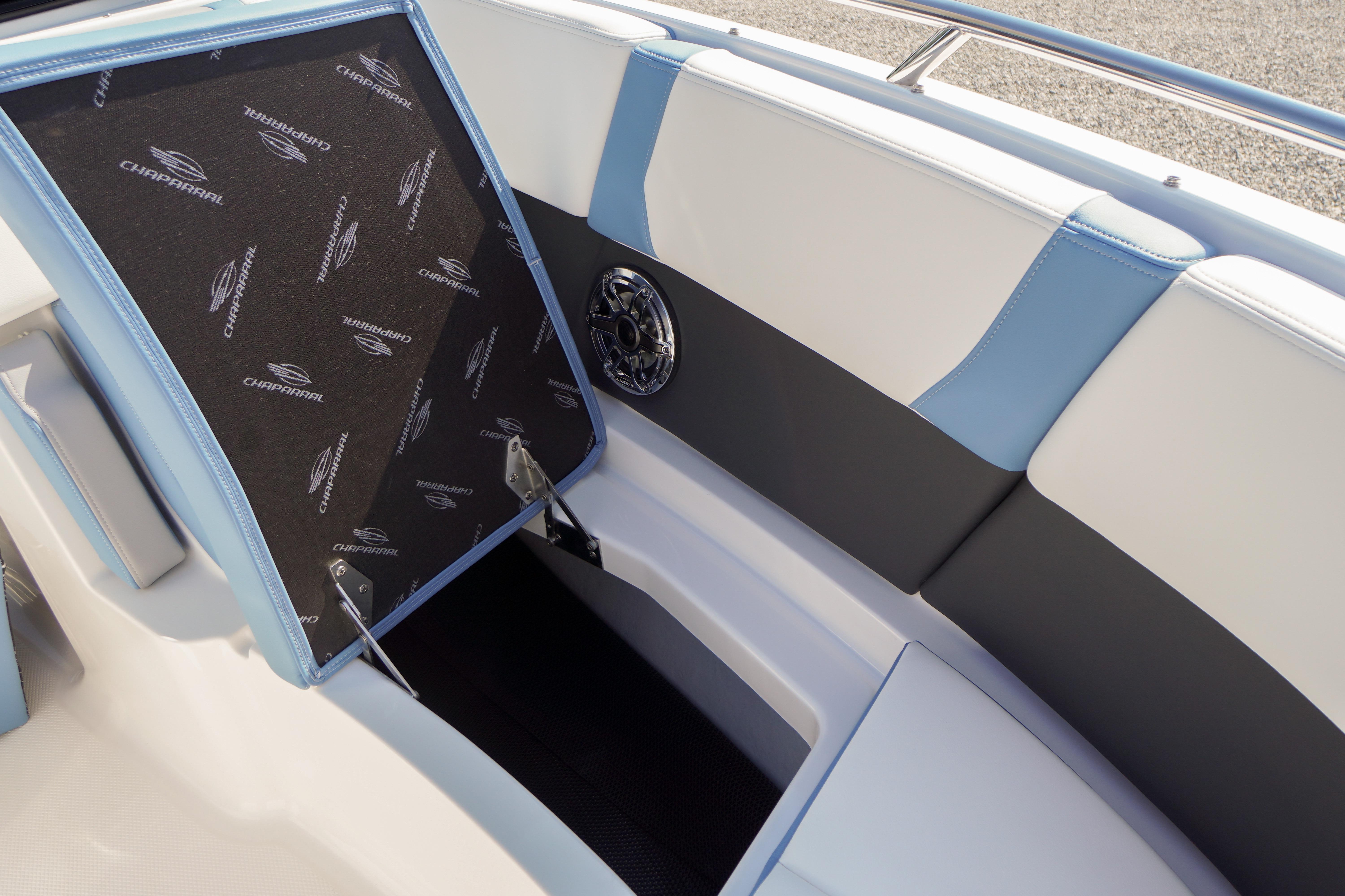 2026 Chaparral 270 OSX boat interior with open storage compartment and speaker detail.