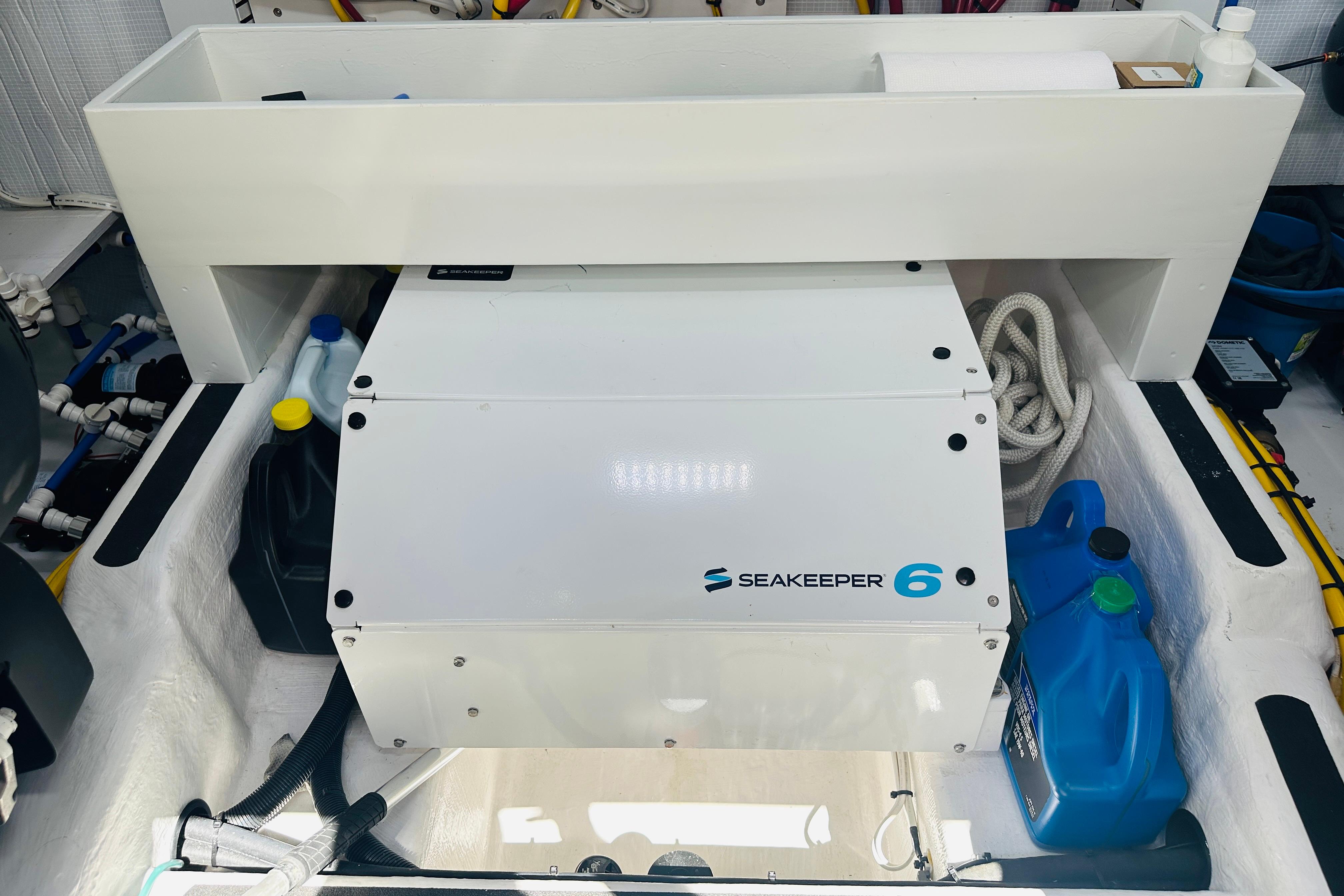 Seakeeper 6 stabilizer in 2025 Sabre 48 Salon Express engine room, surrounded by maintenance supplies.