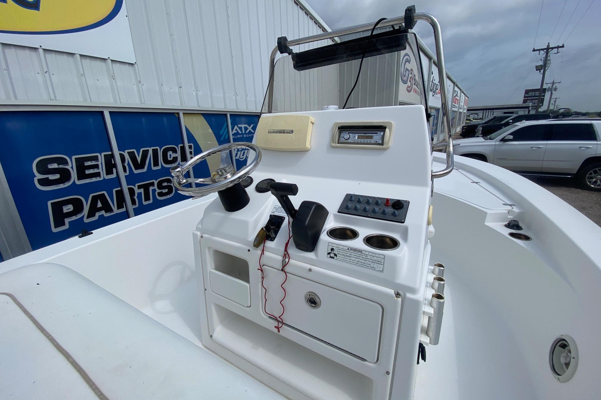 2013 Sportsman Masters 227 Bay Boat console with steering wheel and controls.