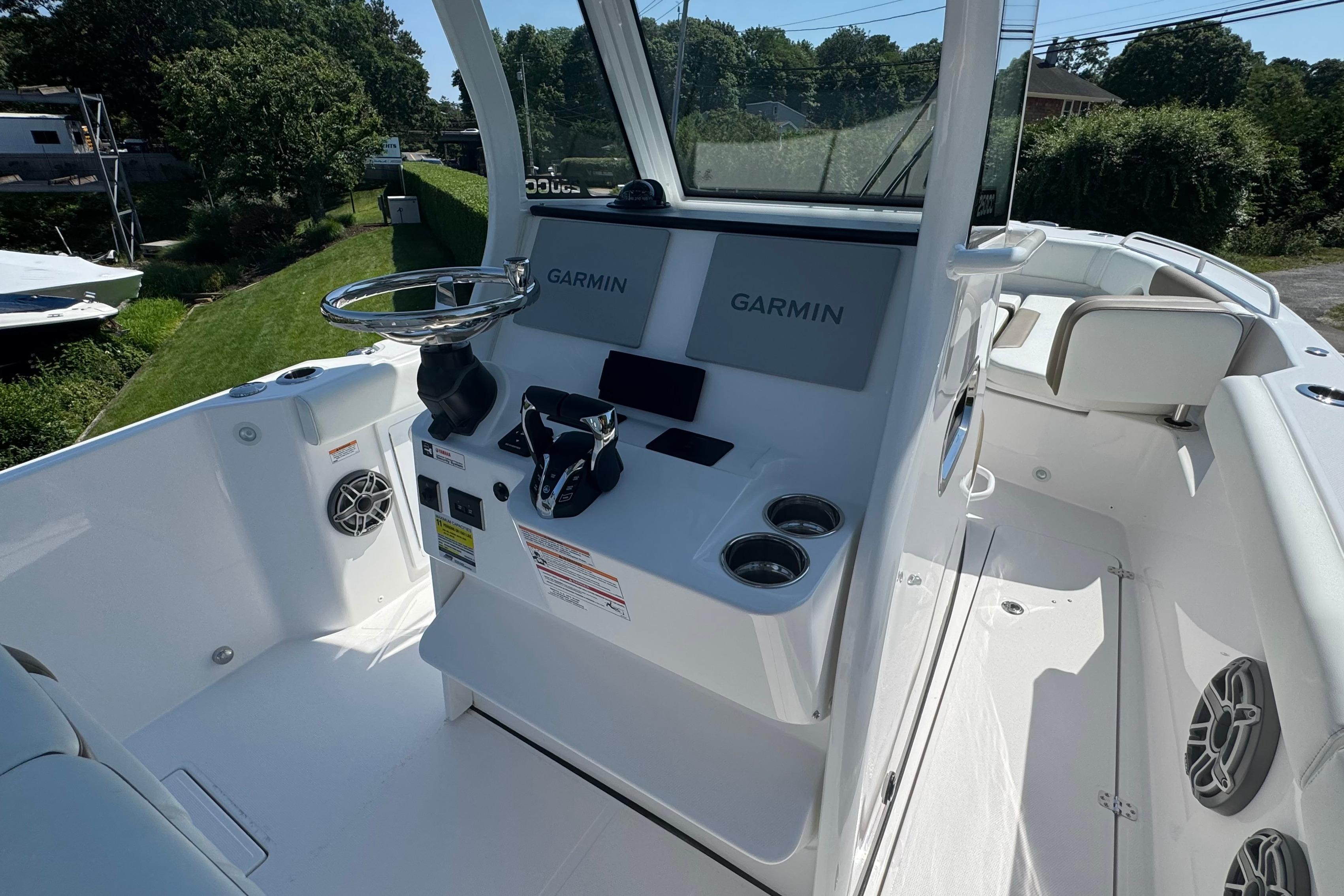 Edgewater 250CC 2026 boat cockpit with Garmin navigation system and sleek white interior.