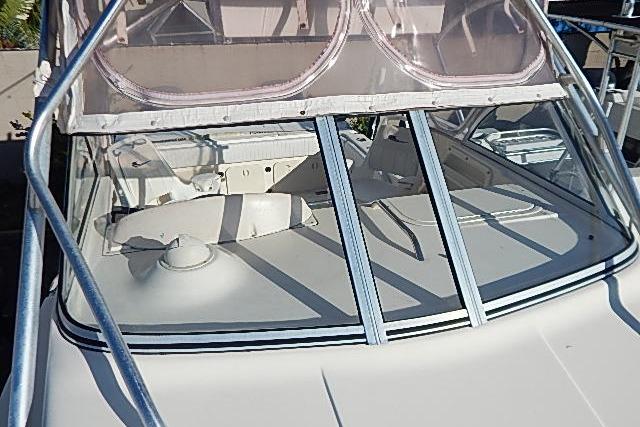 2003 World Cat 270 EC boat with windshield and deck view.