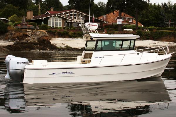 Manufacturer Provided Image: Arima Sea Ranger 21 Hardtop 2026 on calm water near coastal homes.