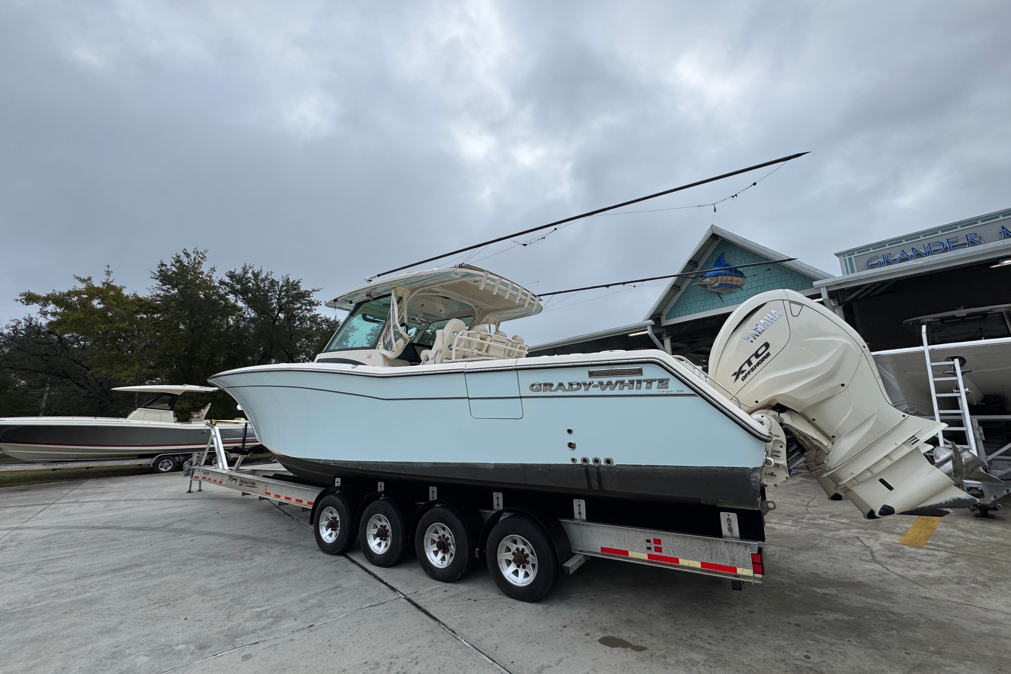 2024 Grady-White Canyon 386 boat on trailer, overcast sky background.