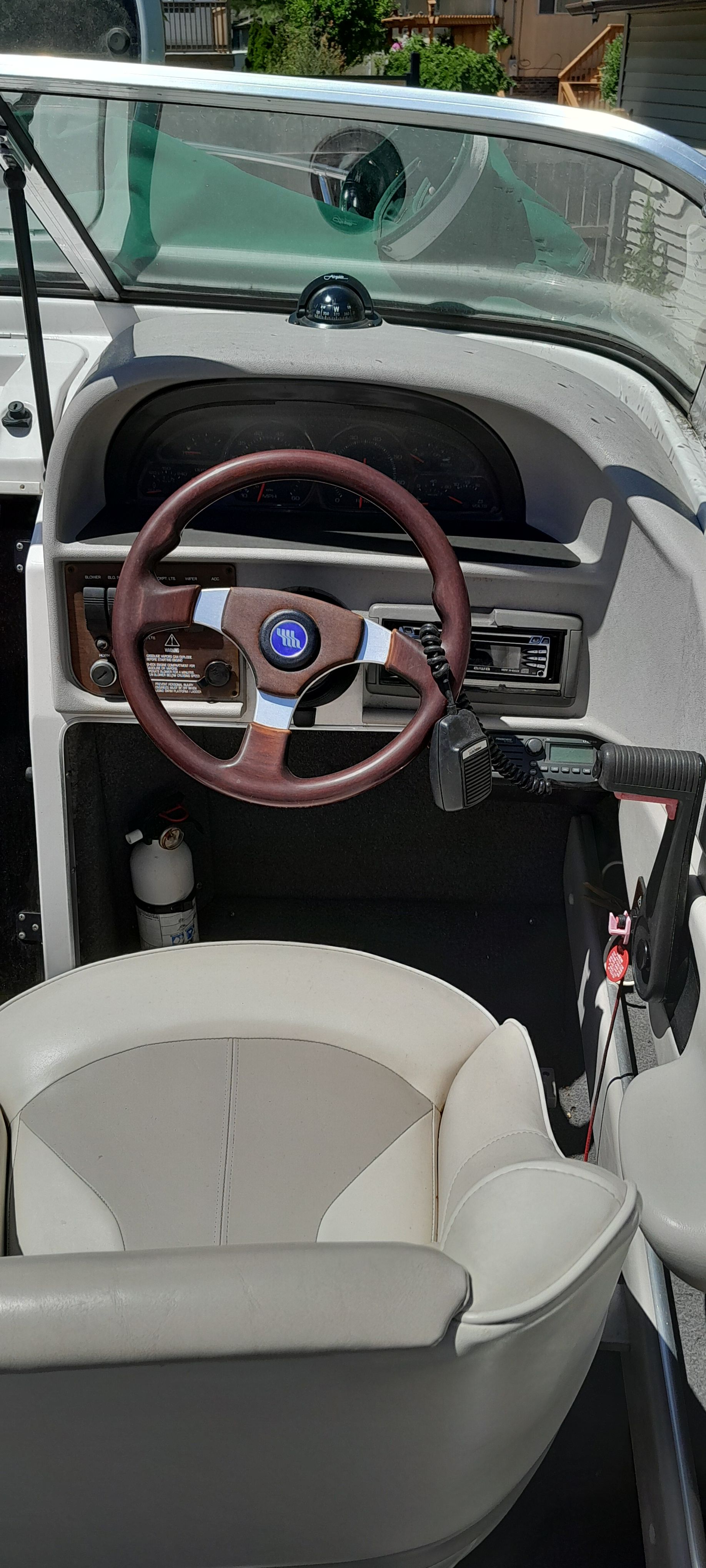 Interior of a 1995 Four Winns 205 Sundowner boat with steering wheel.