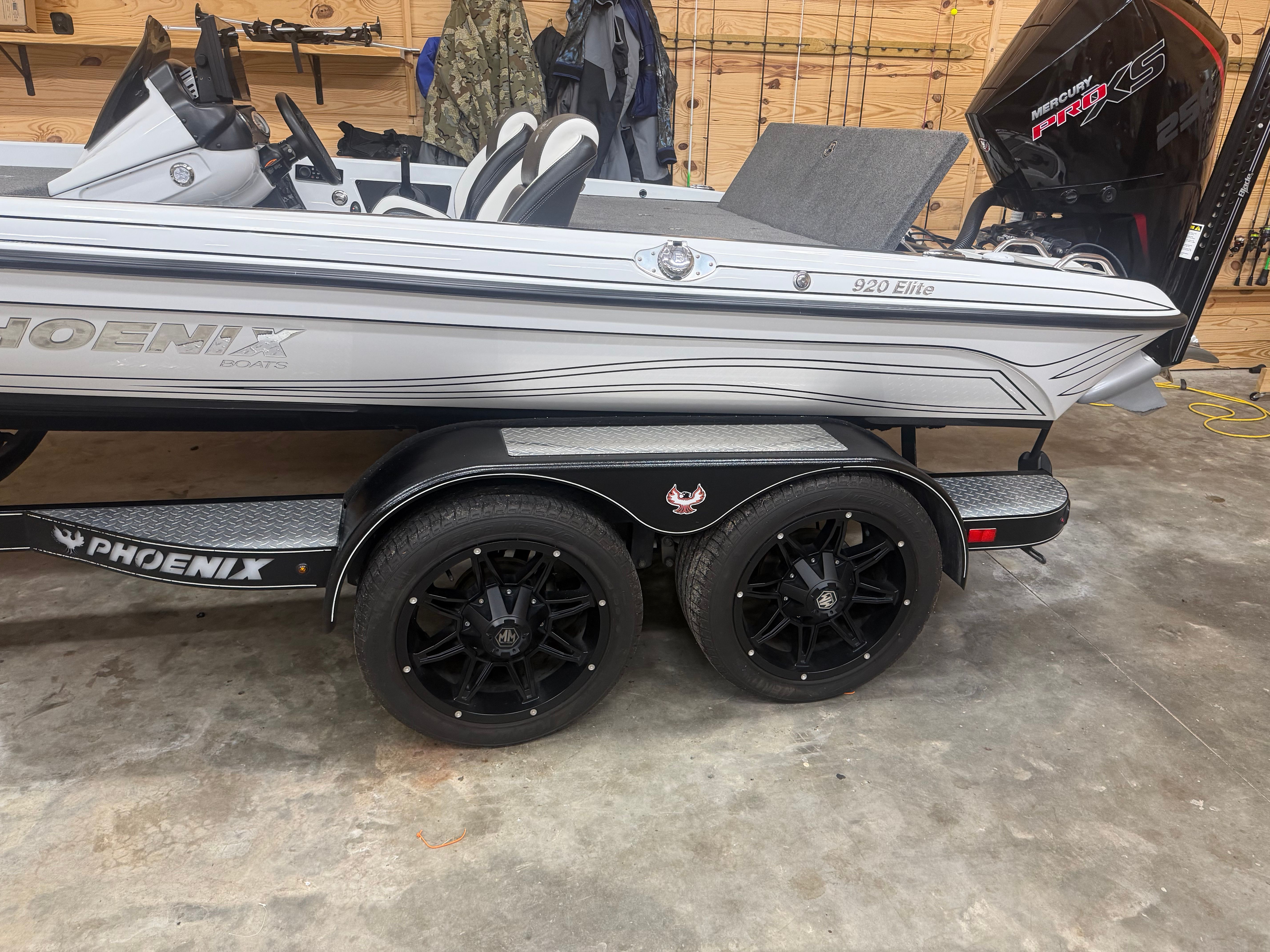 A 2024 Phoenix 920 Elite boat on a trailer in a garage.