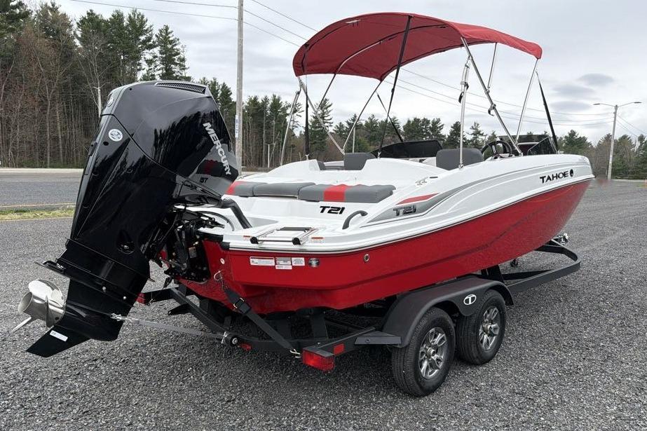 2026 Tahoe T21 boat with red hull and Mercury outboard motor on trailer.