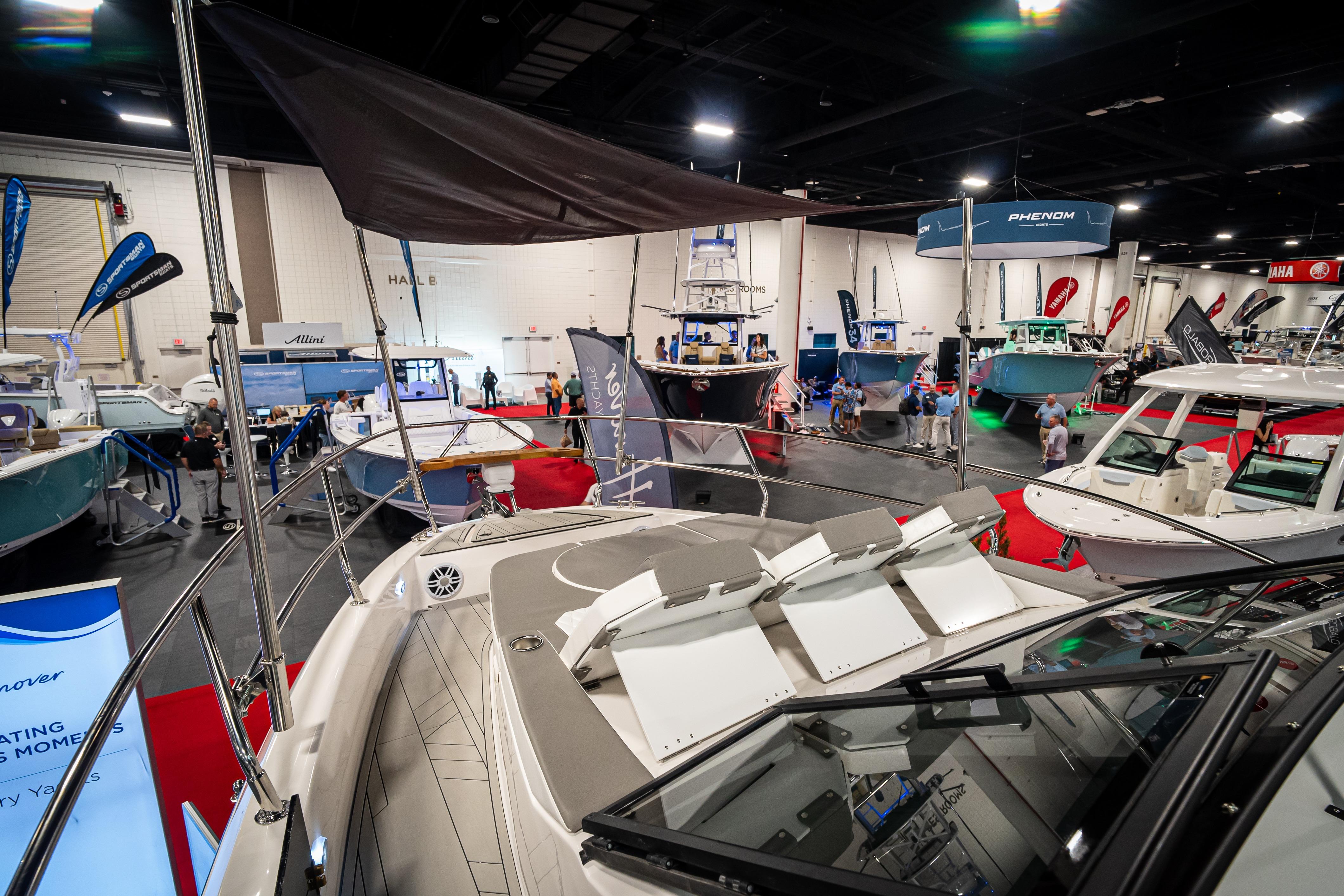 Boat show featuring Hanover 347 model, 2026, with various yachts and attendees in a large indoor venue.