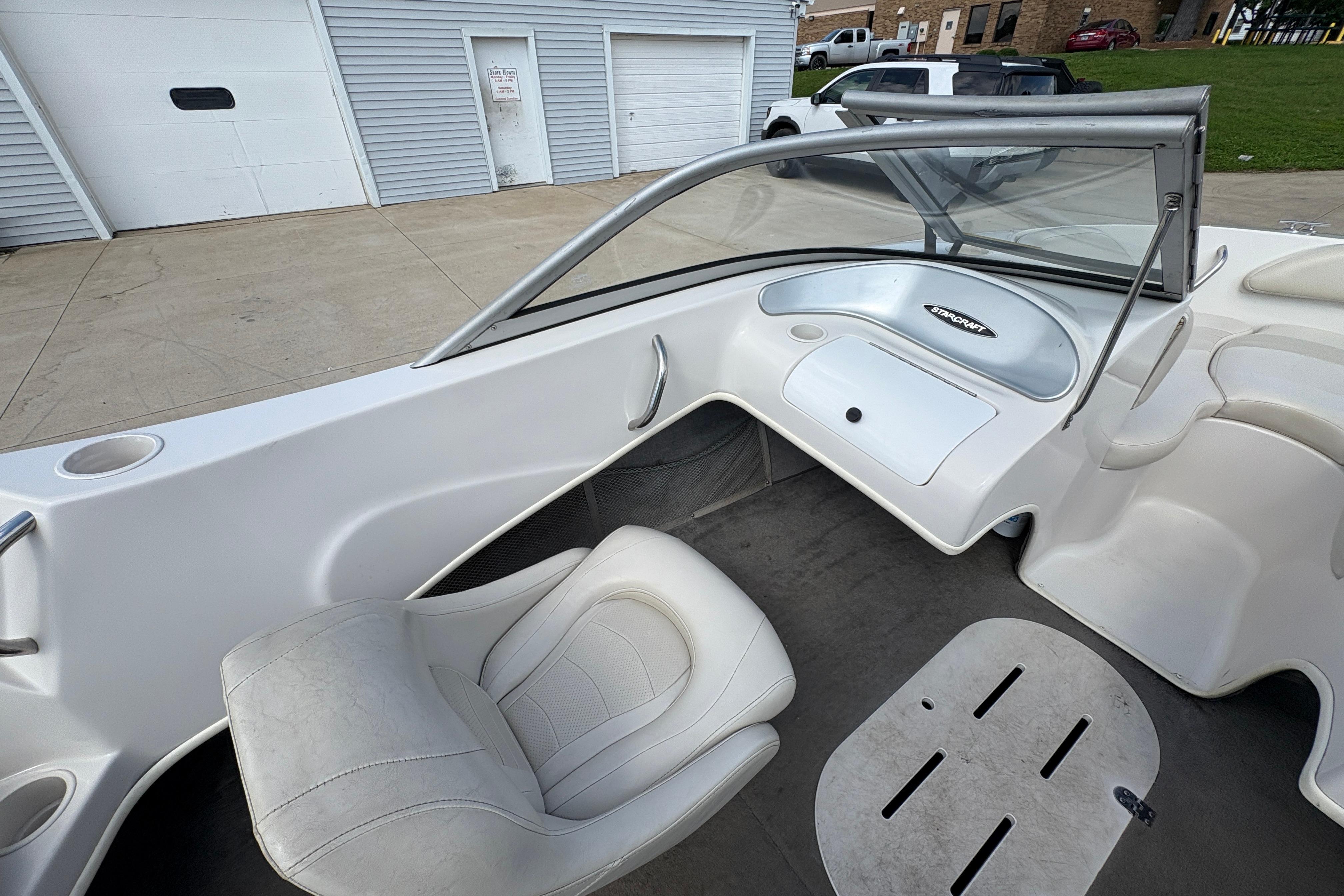 2005 Starcraft C-Star 1700 OB boat interior with white seating and dashboard.