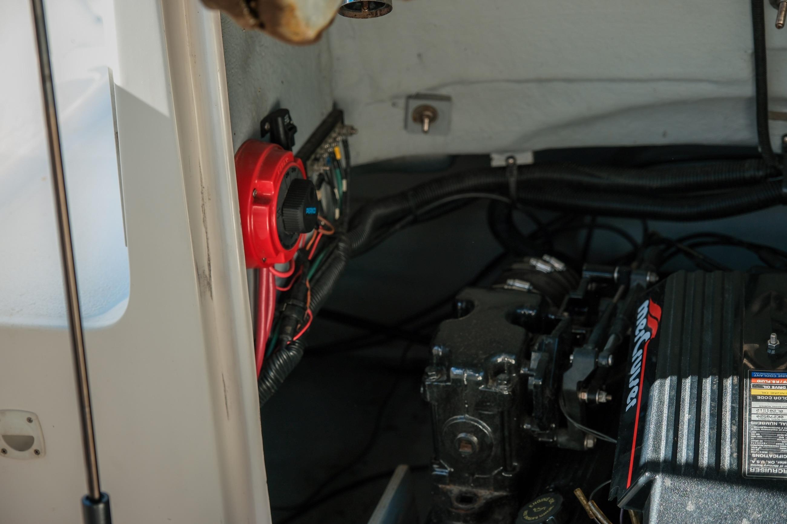 Engine compartment of a 1998 Chaparral 232 Sunesta boat, featuring mechanical components.