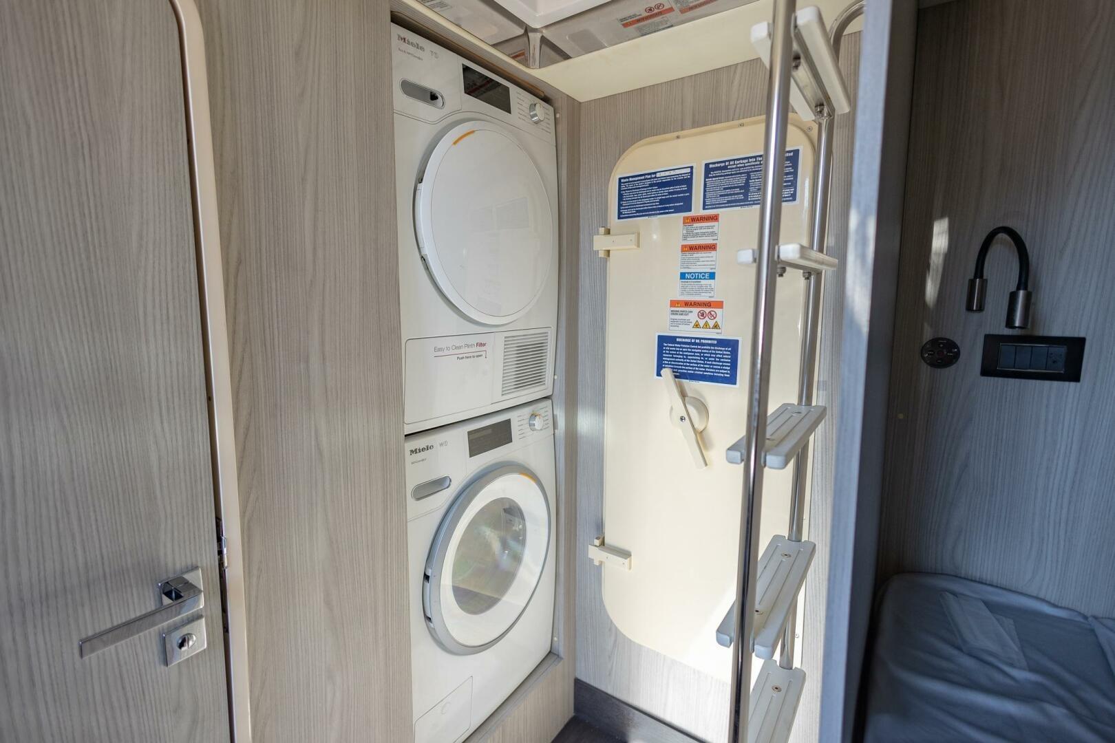 Laundry area with stacked washer and dryer on Azimut Fly 72 yacht, 2021 model.