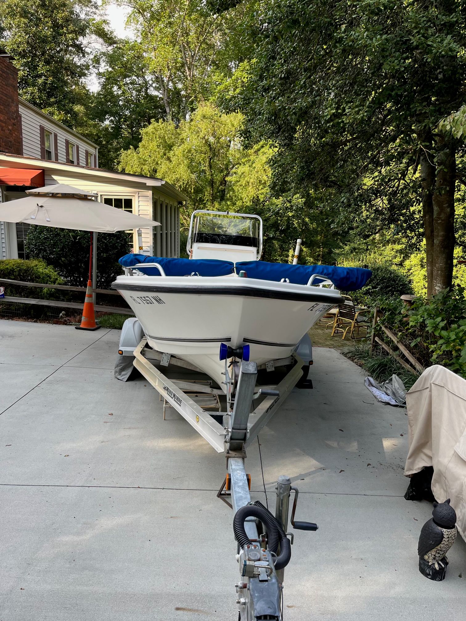 2006 Mako 171 Center Console boat on trailer in driveway.