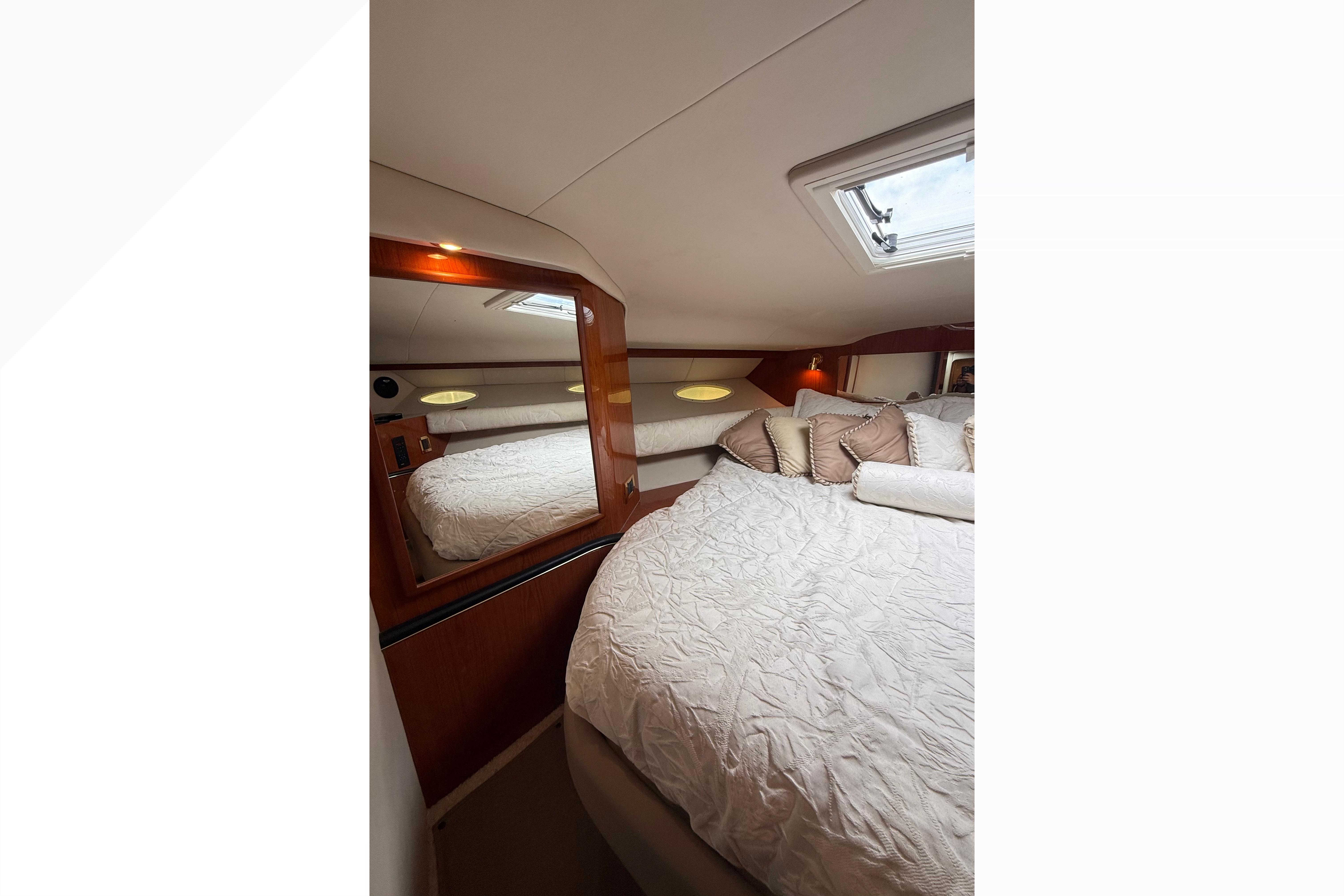 Luxurious cabin interior of 1998 Sea Ray Sundancer 400 yacht with plush bedding.