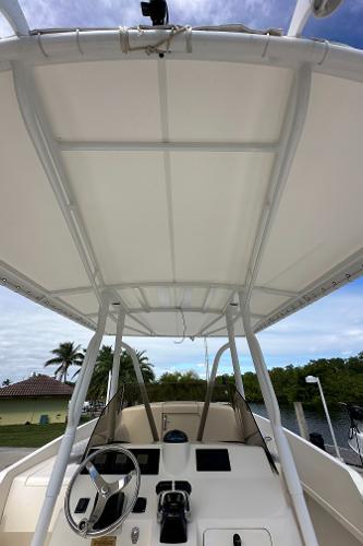 2005 Intrepid 323 boat helm with canopy, steering wheel, and controls.