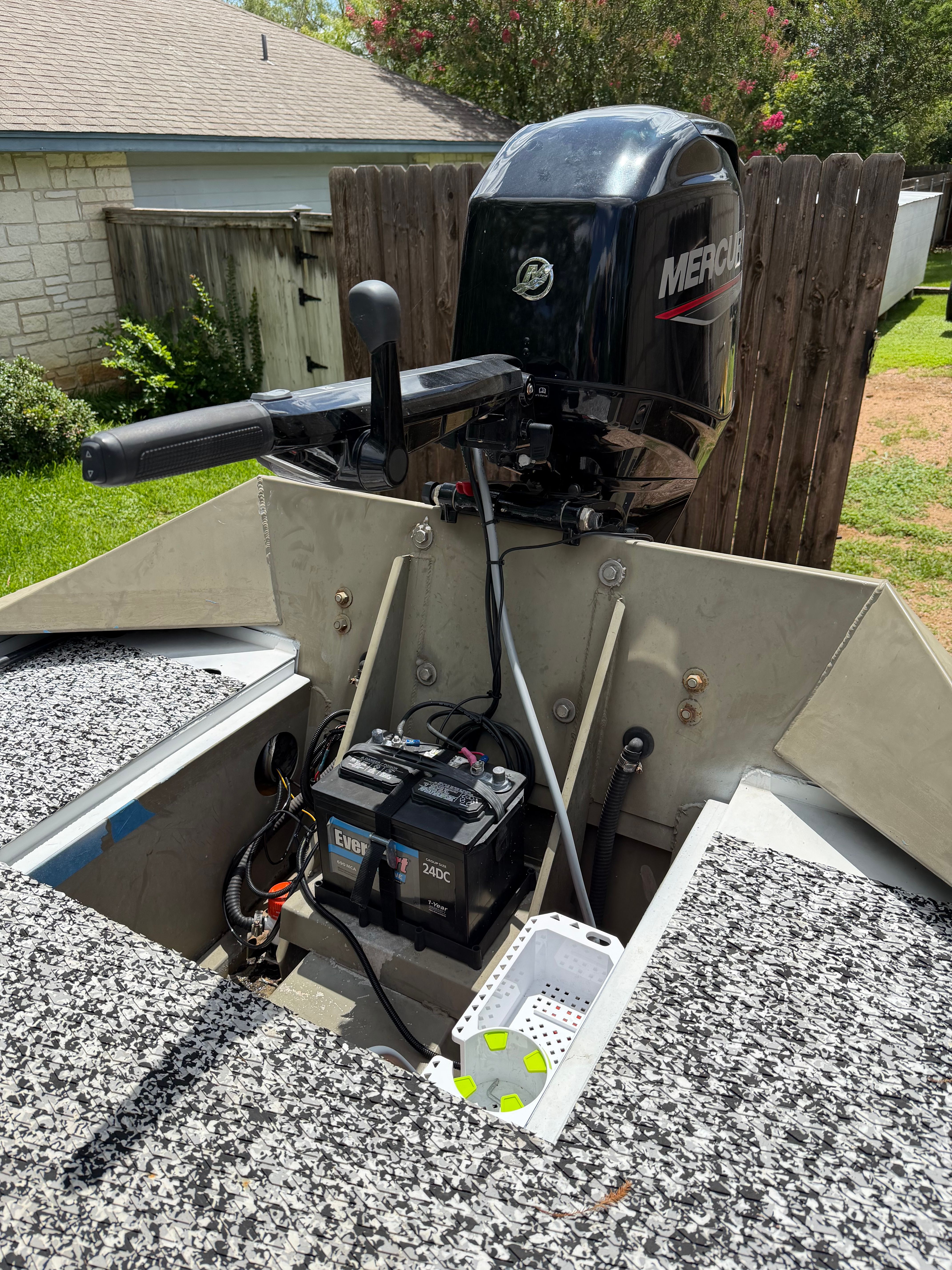 2008 Alumacraft Fisherman 160 Tiller with Mercury motor in backyard.
