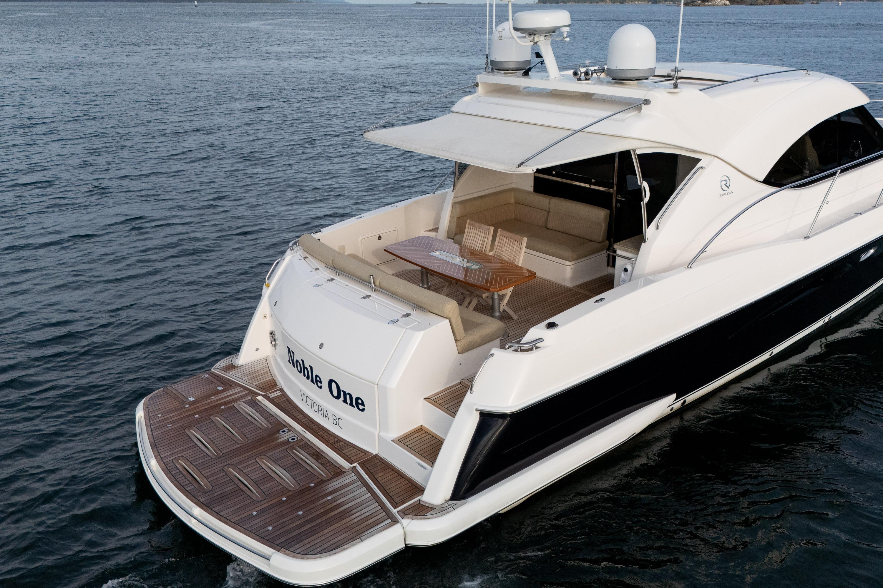 2011 Riviera 5000 Sport Yacht on water, featuring elegant deck and seating area.