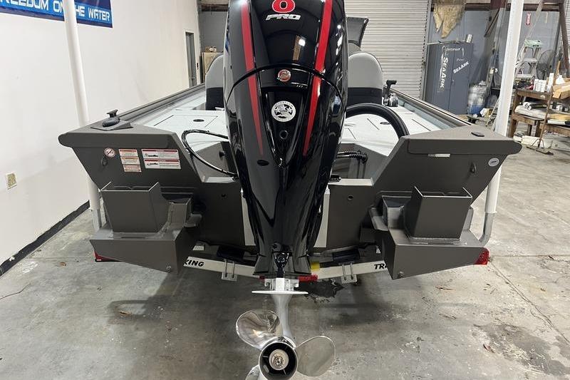 2026 SeaArk Flex 19 Pro boat with powerful outboard motor in a garage setting.