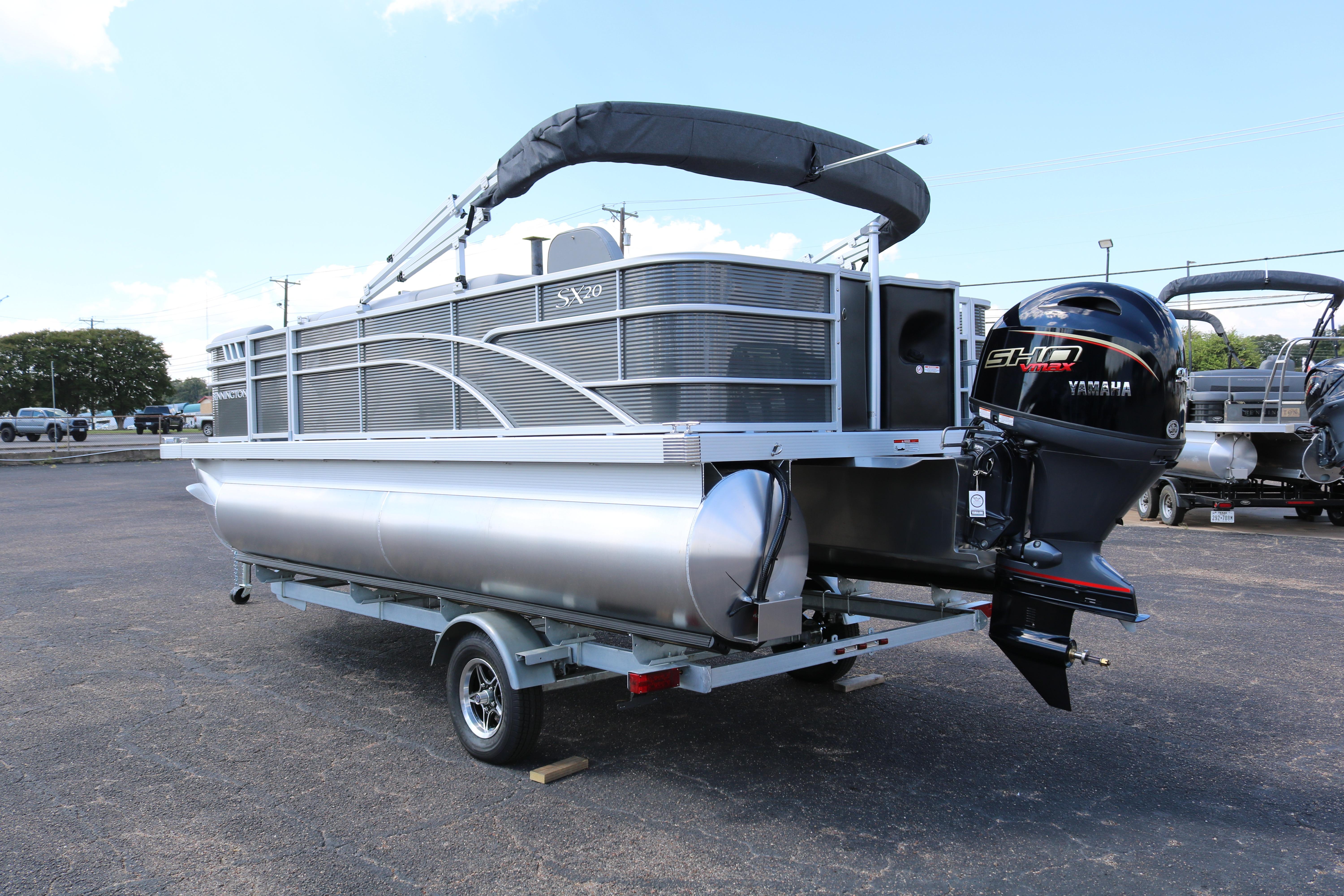 2026 Bennington 20SXSNP REAR FISH pontoon boat with Yamaha outboard motor on trailer.