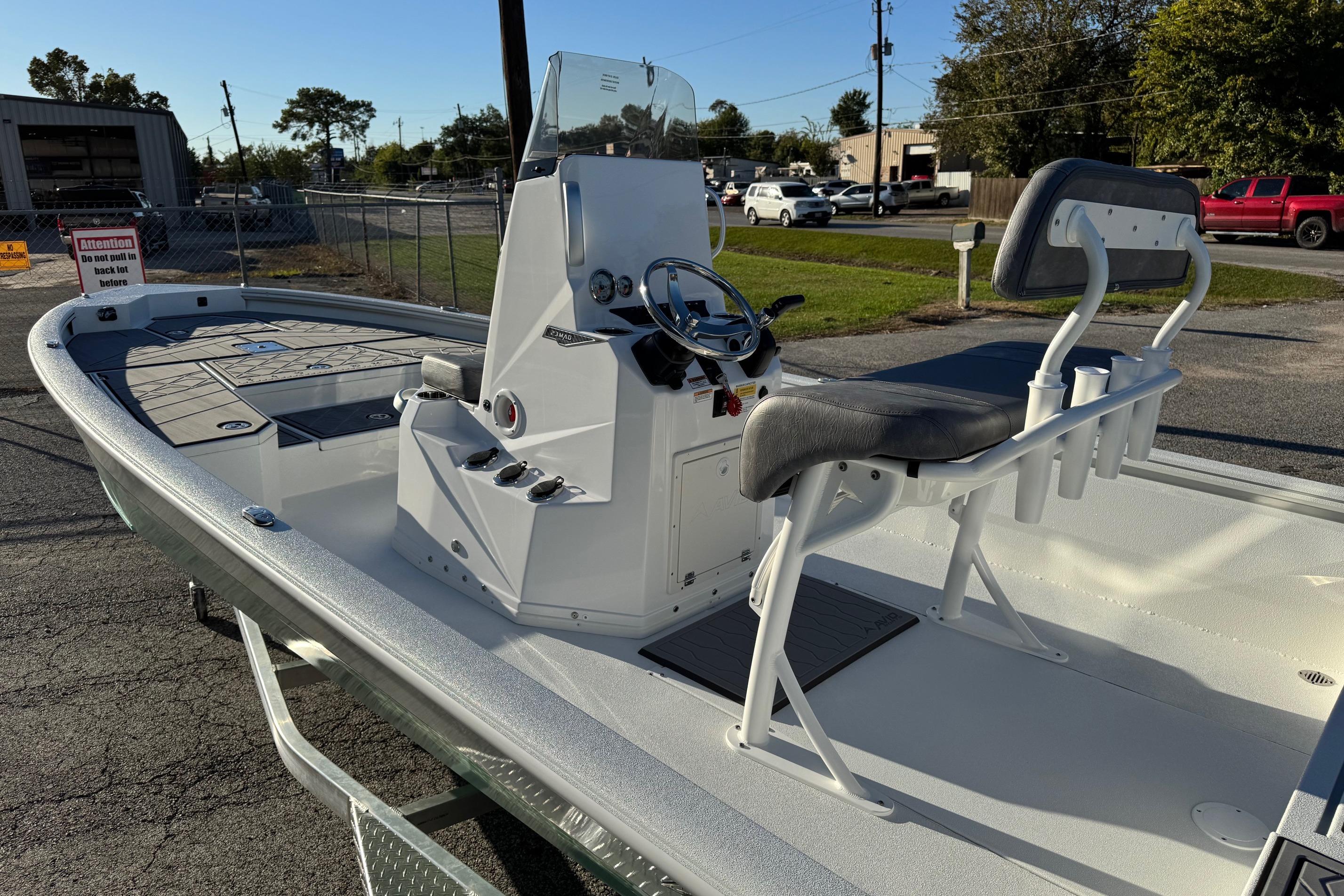 Avid 23 Mag 2025 boat with sleek design and modern console, parked outdoors.