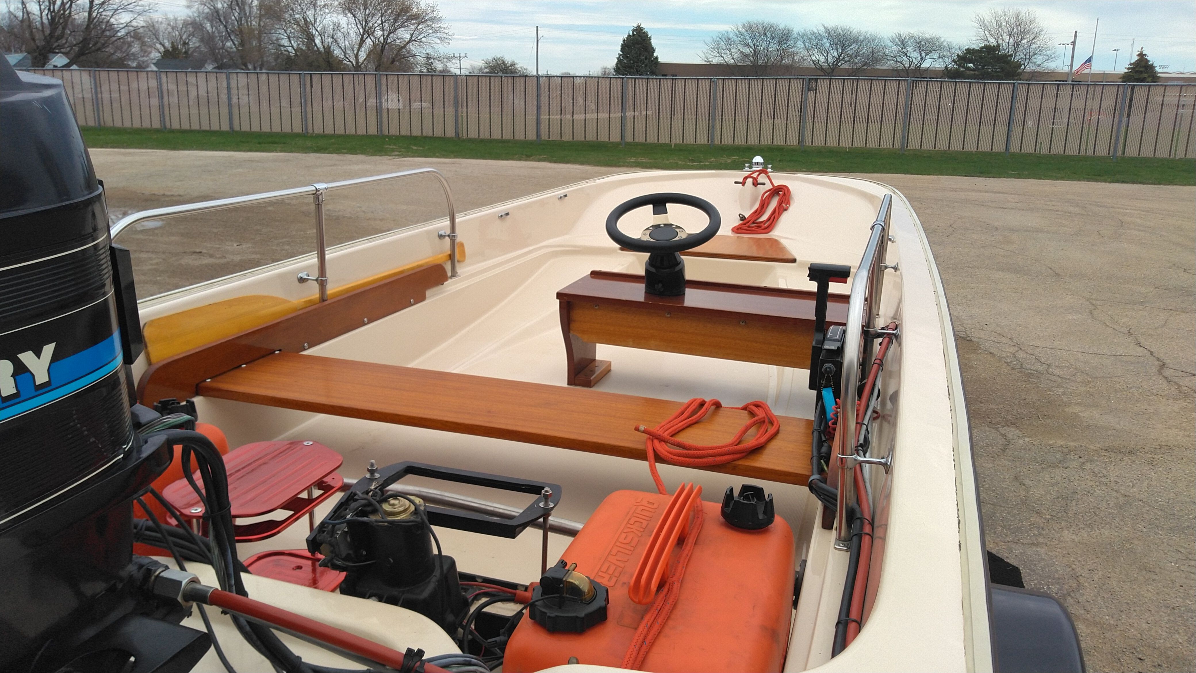 1976 Boston Whaler Sport 15 boat with outboard motor and wooden details.