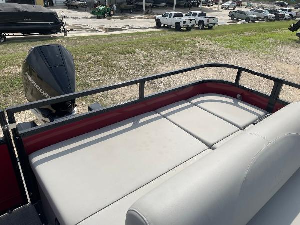 2023 Regency 250DL3 pontoon boat with spacious seating and powerful outboard motor.