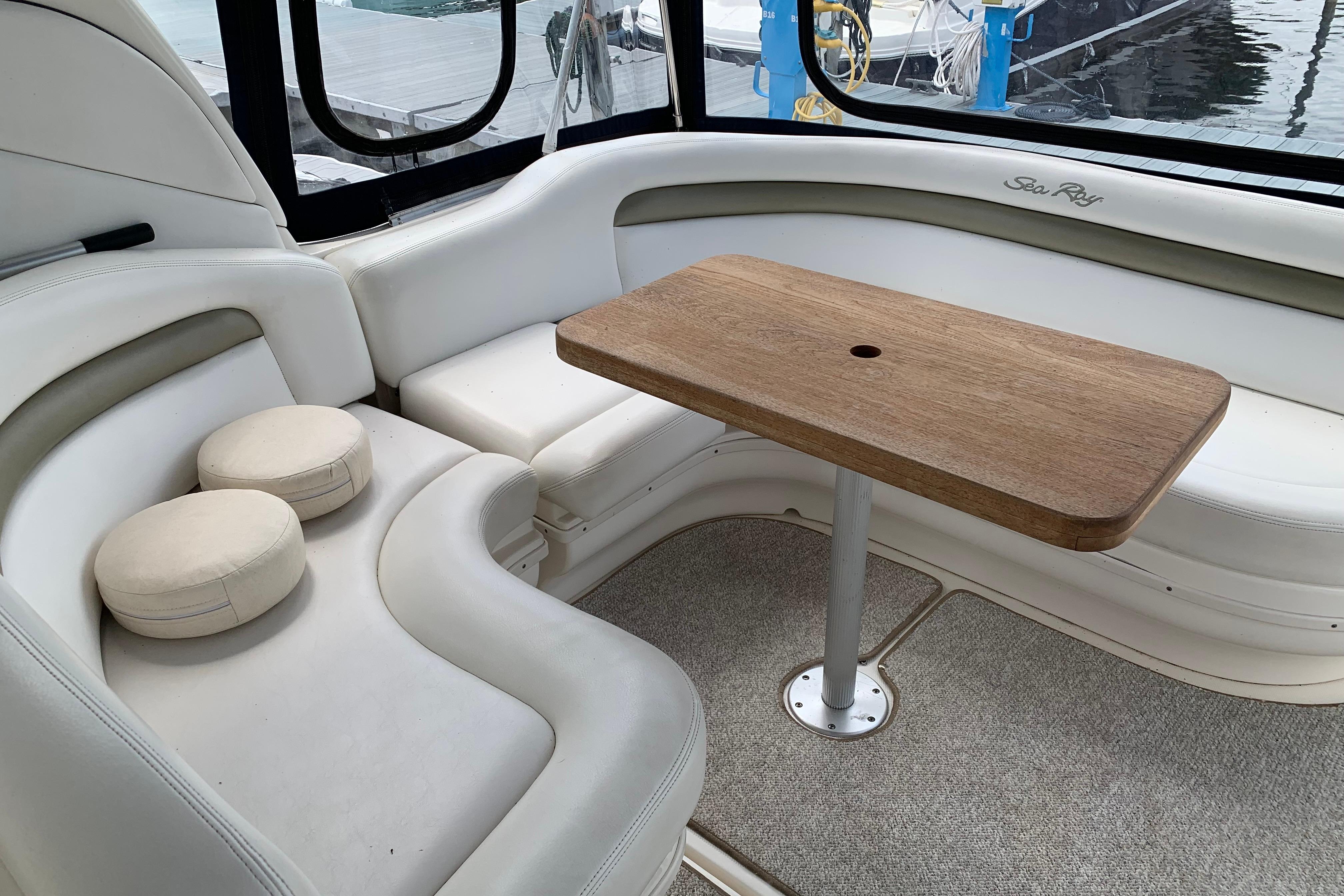 Luxurious interior of 2007 Sea Ray 340 Sundancer with elegant seating and wooden table.