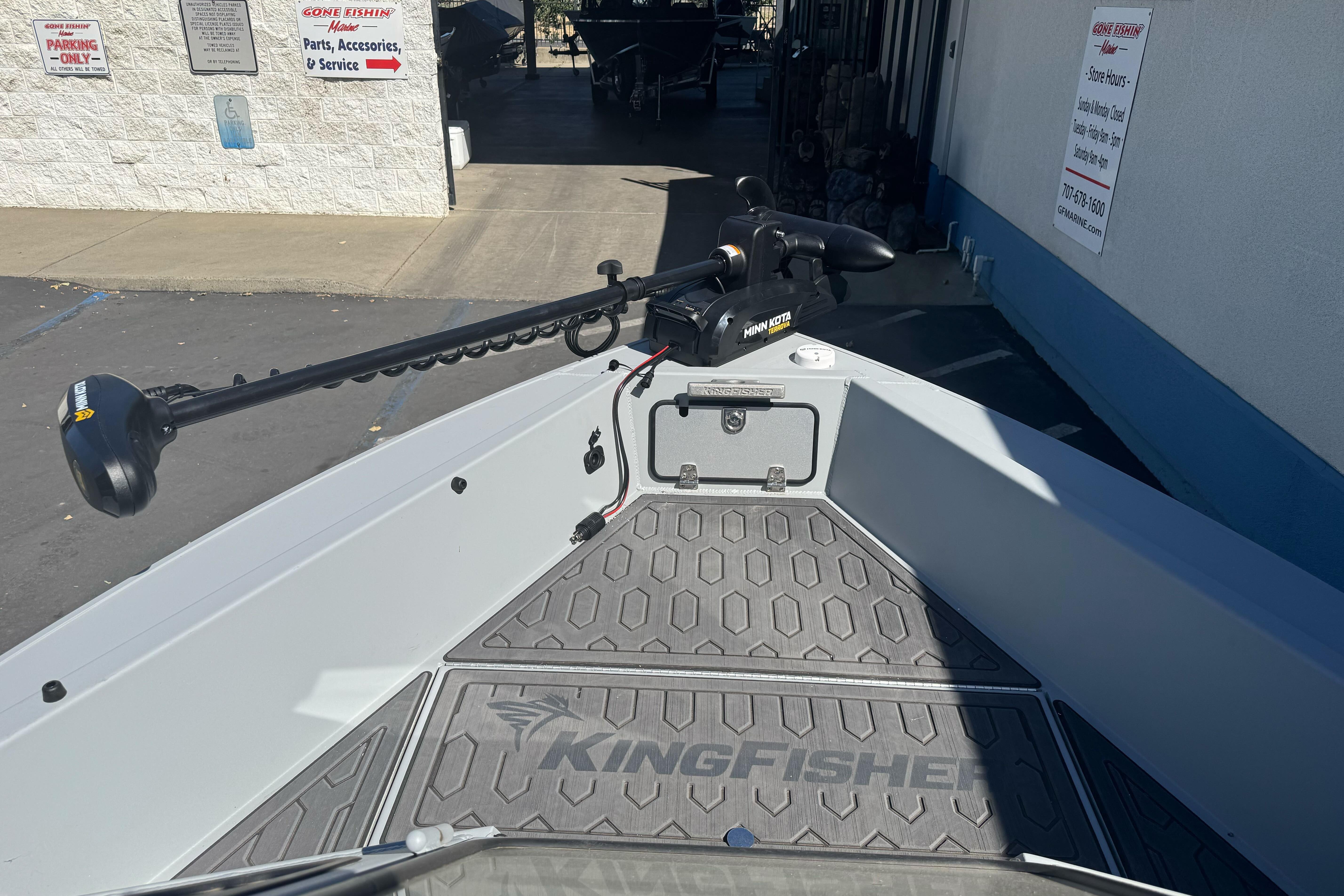 2026 KingFisher 16 Falcon boat with Minn Kota trolling motor at a service center.