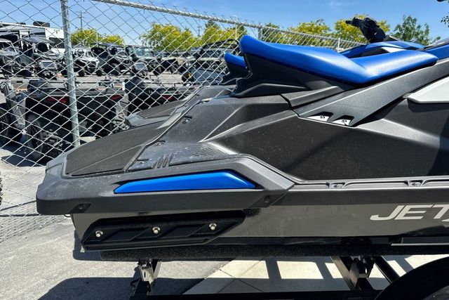 A black 2026 Yamaha WaveRunner Jetblaster on a trailer next to a chain-link fence.