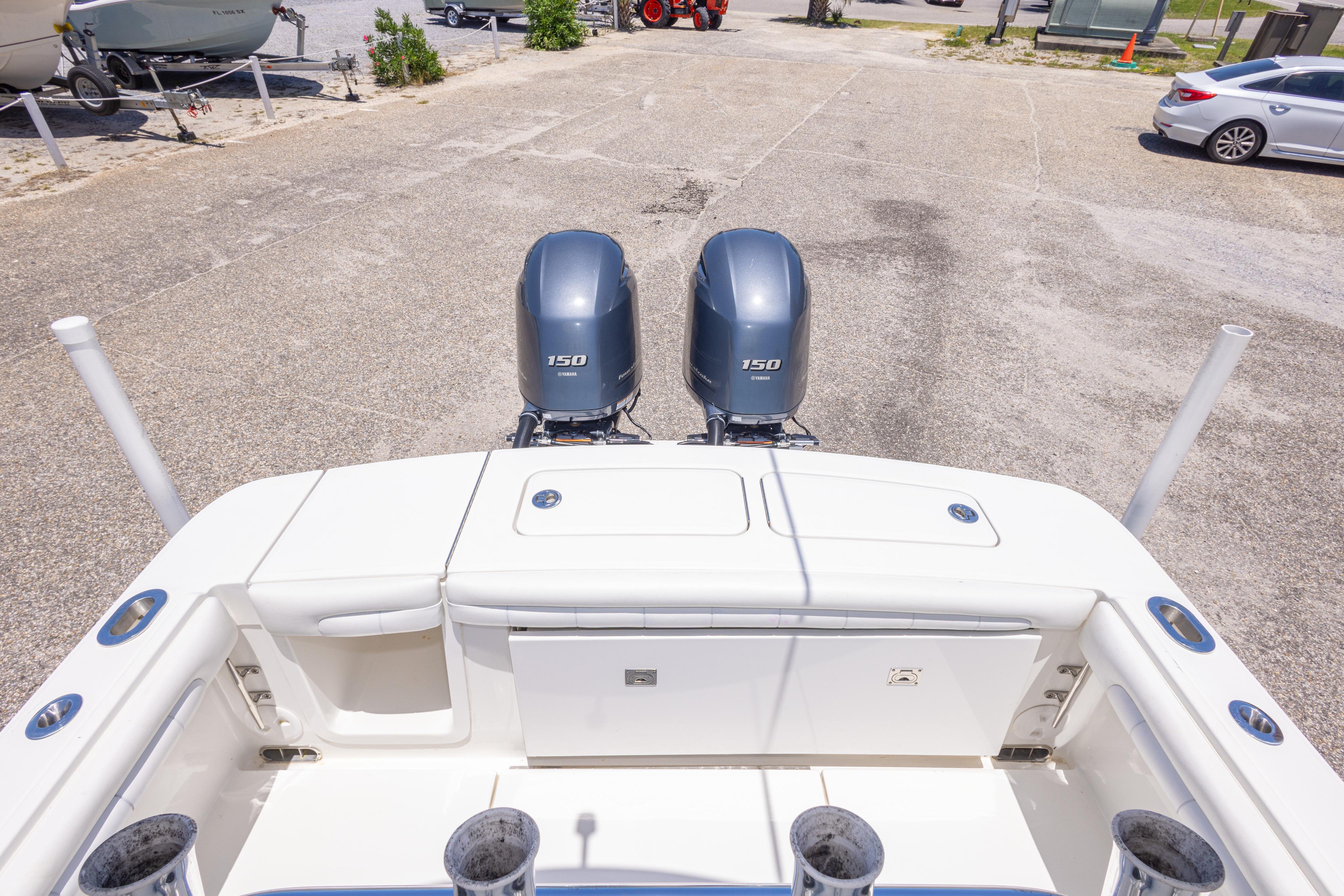 2019 Regulator 23 Center Console boat with twin 150 horsepower engines, docked on pavement.
