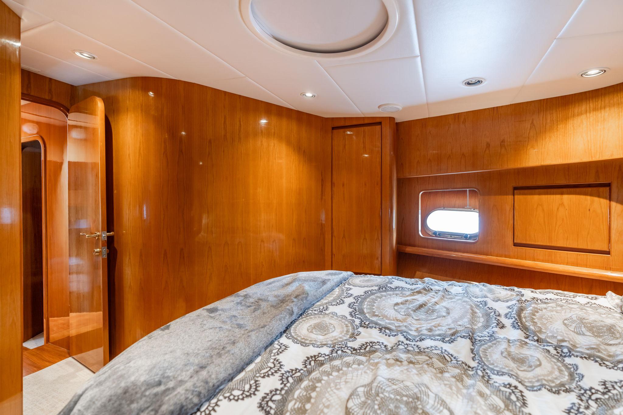 Luxurious cabin interior of 1999 Vitech 68' Pilothouse yacht with elegant wood paneling.