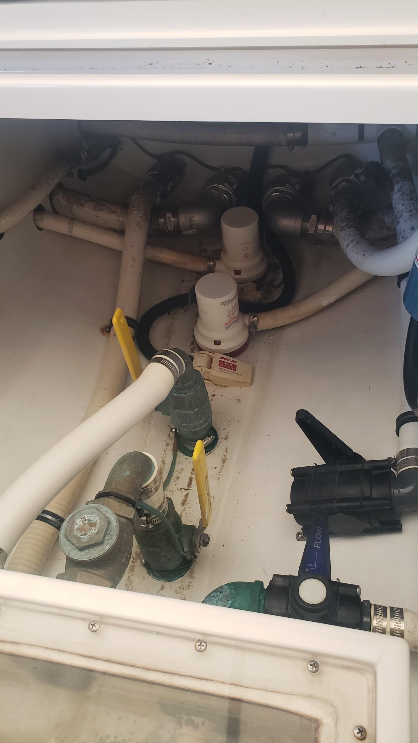 2017 Invincible 33 Open Fisherman boat plumbing system with valves and hoses.