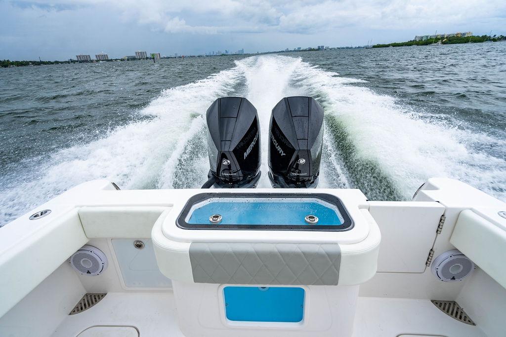 Reef Runner 280 boat cruising with dual engines, 2027 model, on open water.