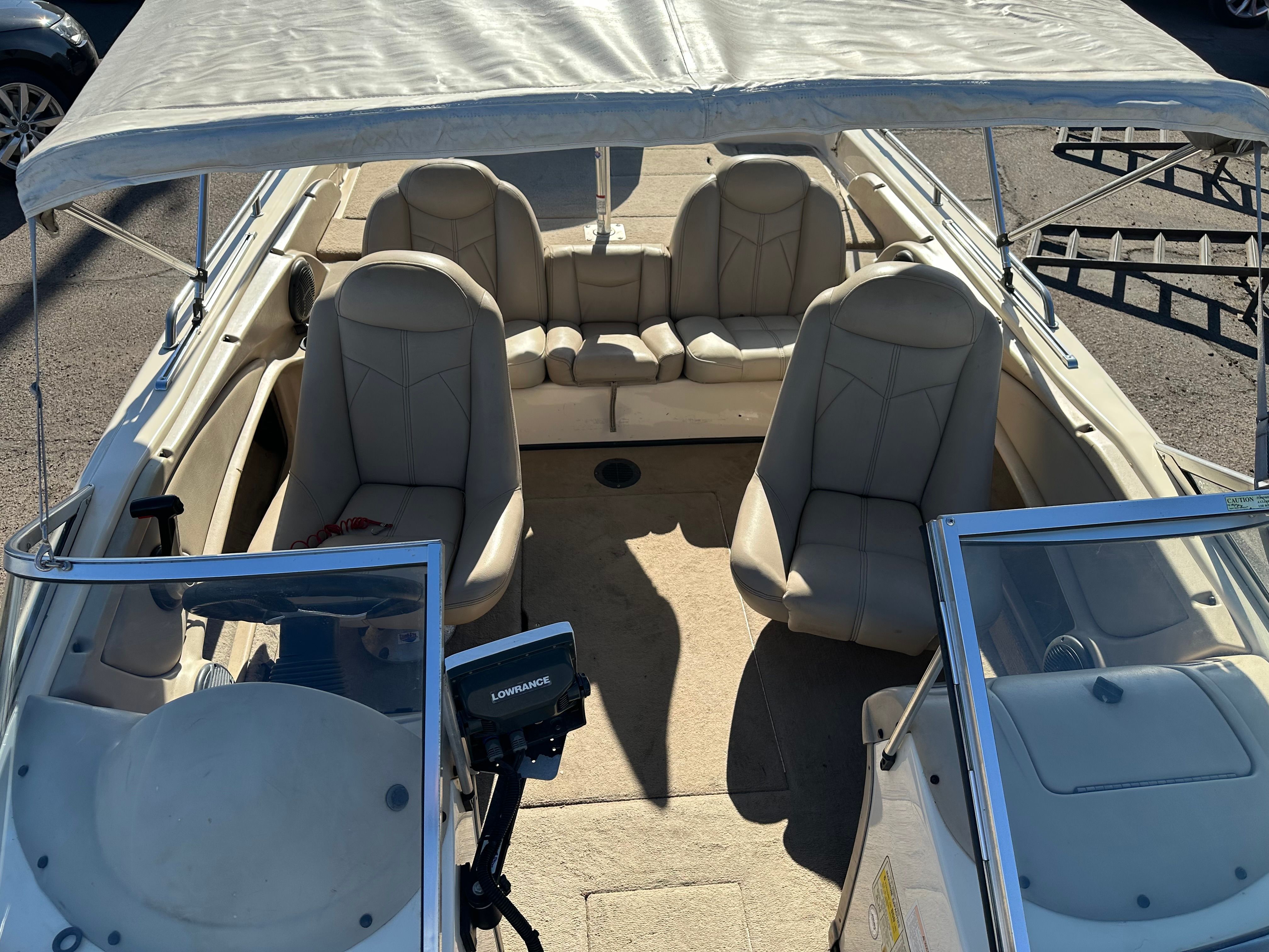 The image shows the interior of a 2008 Skeeter SL 210 boat with beige seating.